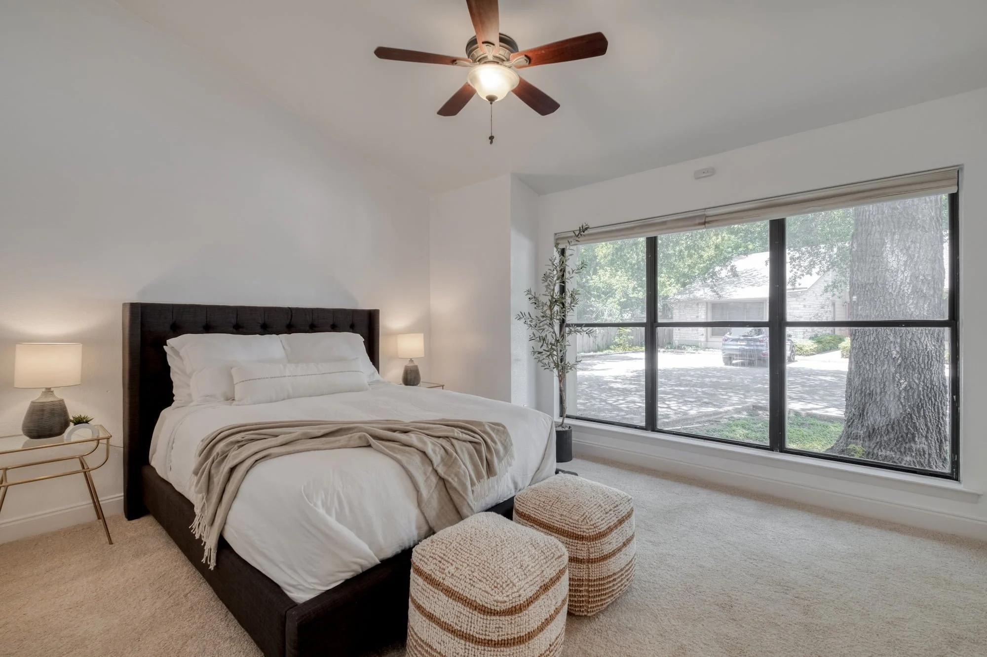 Staged bedroom with oversized window and natural light