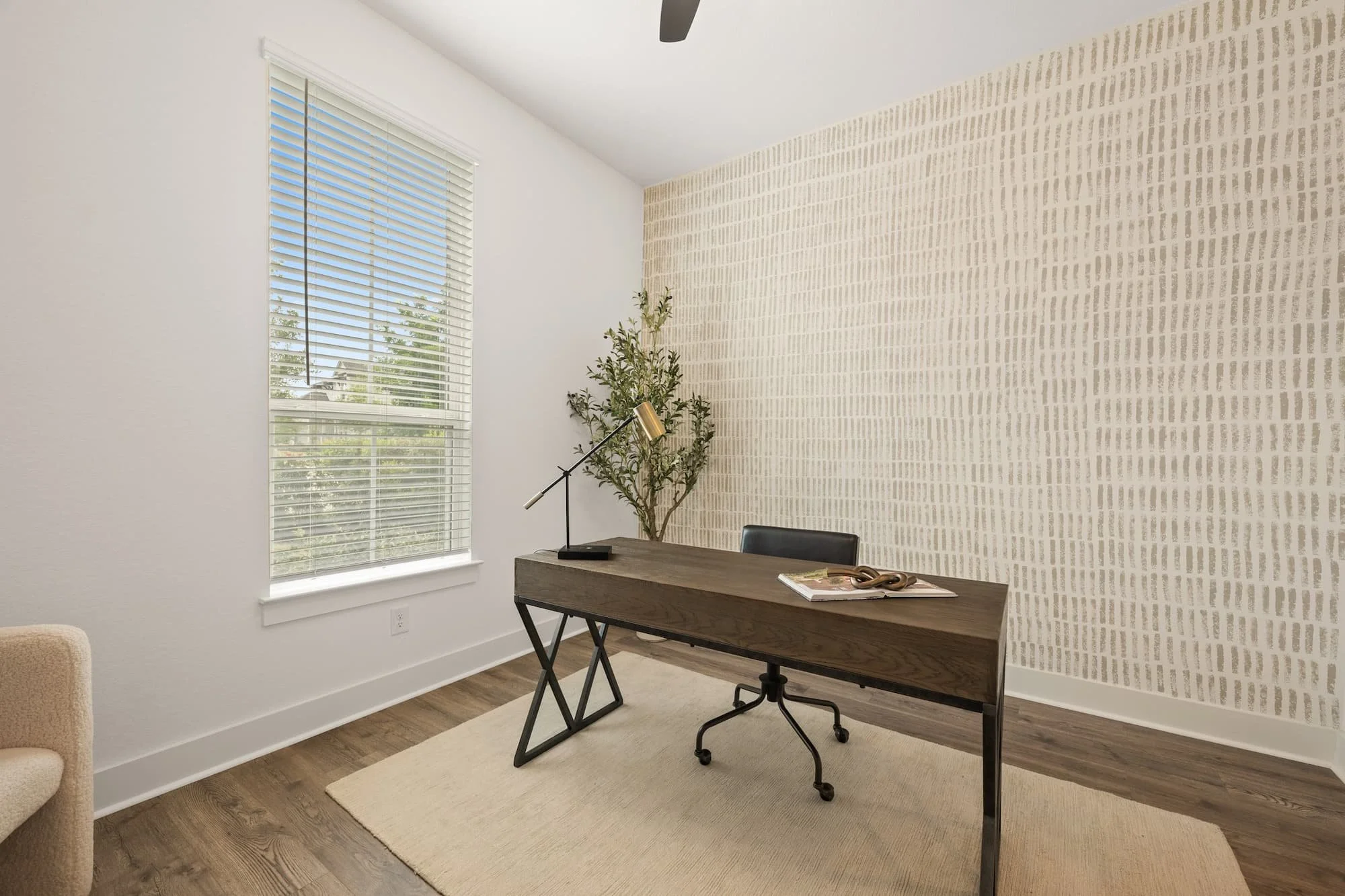 Private home office with designer accent wall, natural light, and stylish modern staging in Leander, Texas