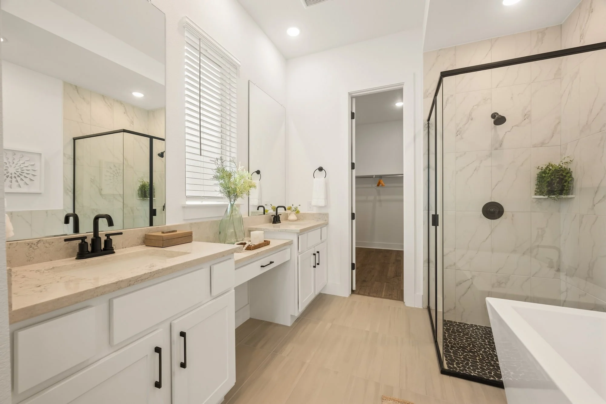 Spa-inspired primary bathroom with dual sinks and designer tile finishes