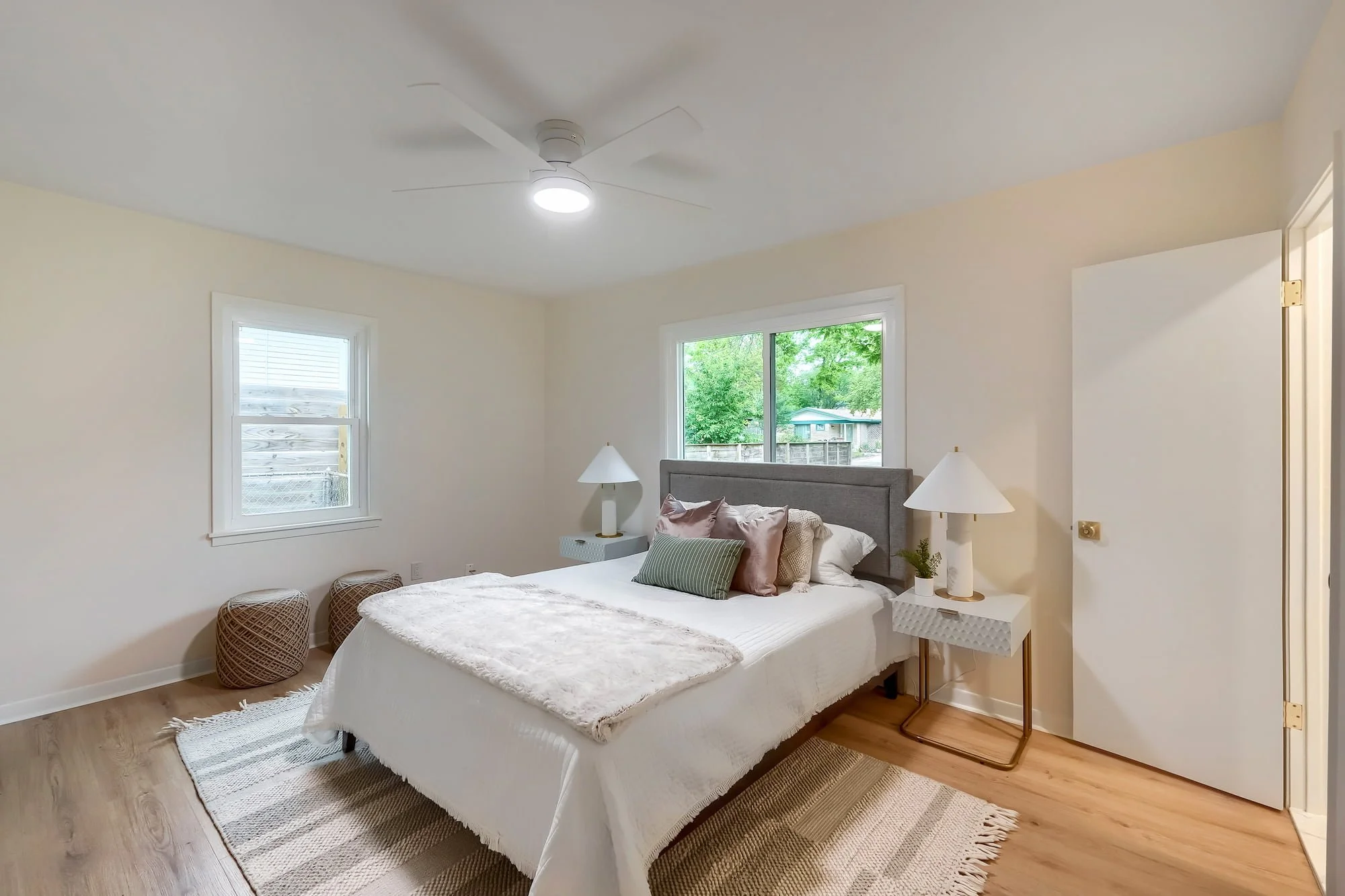 Comfortable bedroom retreat with abundant natural light and warm wood-look flooring, located in Garrison Park, South Austin.