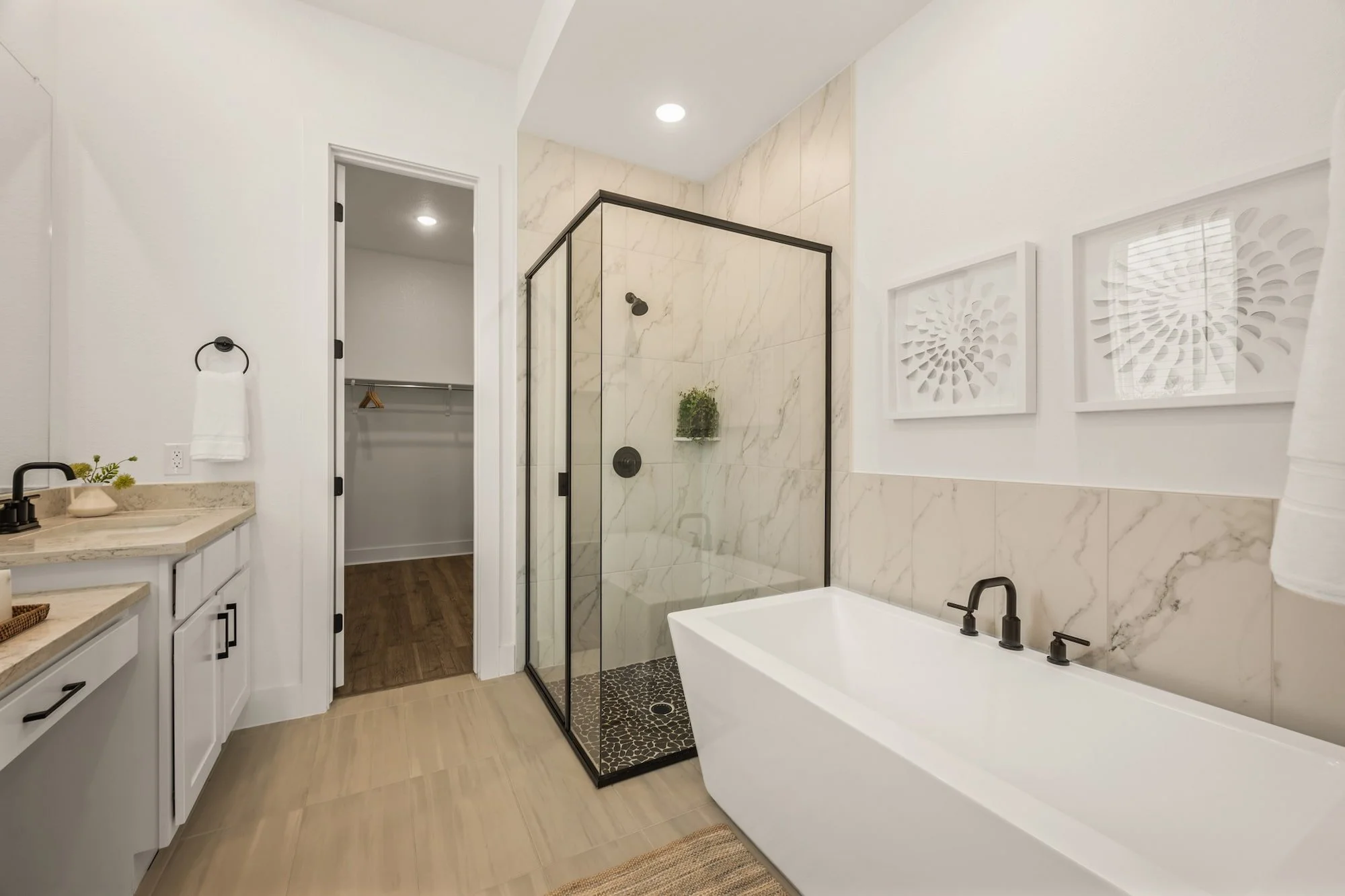 Luxury primary bath featuring a soaking tub, walk-in shower, and walk-in closet
in Leander, TX