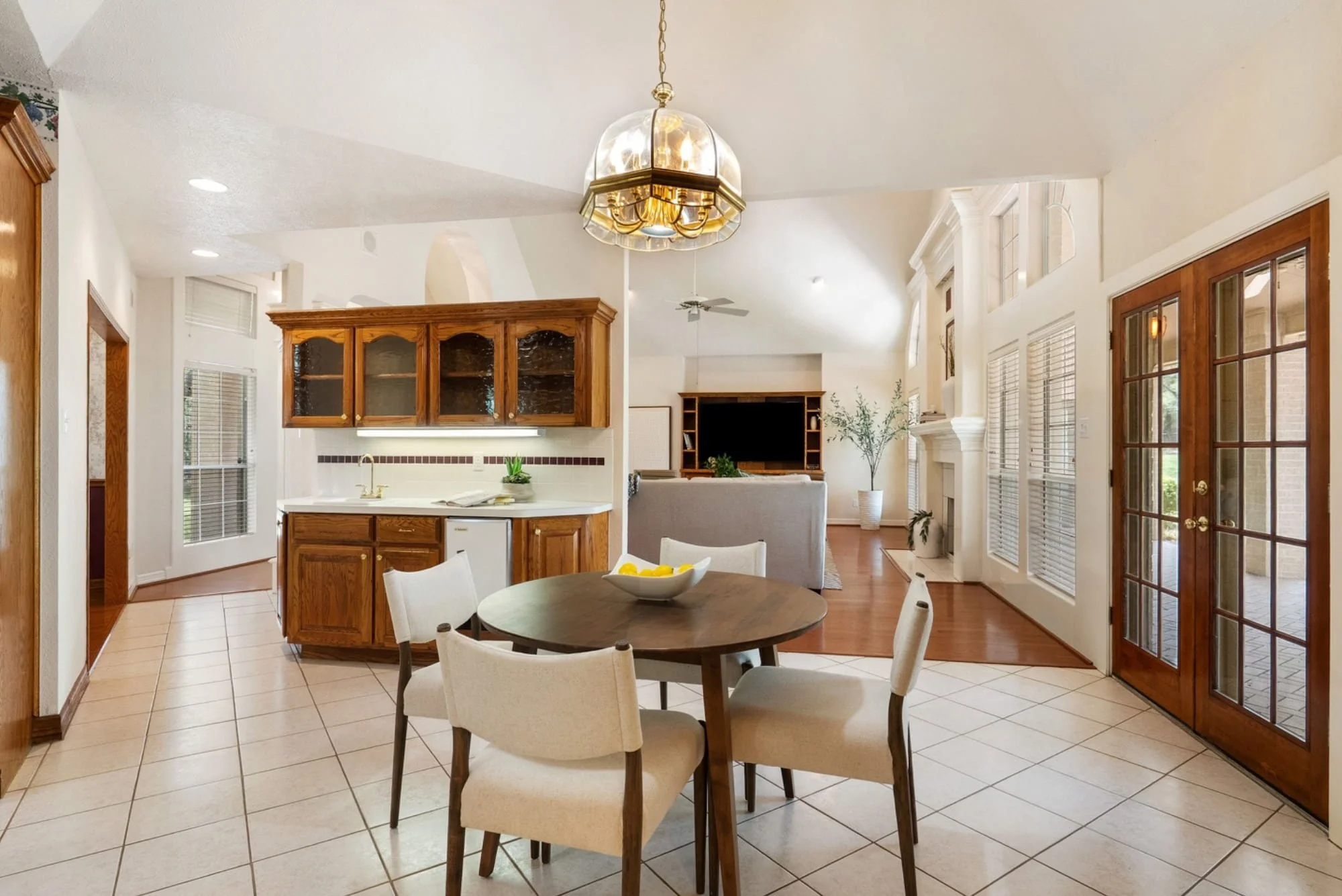 Breakfast area with a round dining table, built-in cabinetry, and access to the outdoor patio.