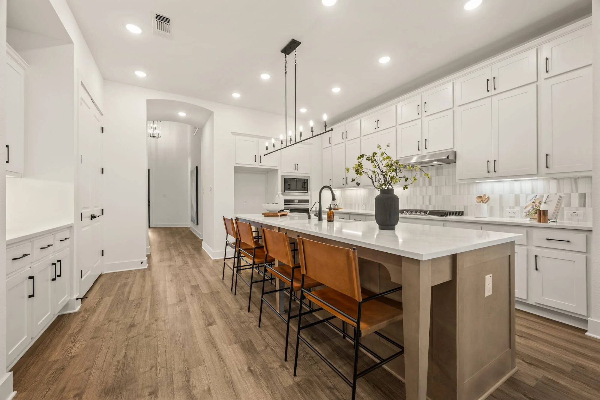 Designer kitchen with oversized island, extensive cabinetry, and bar seating