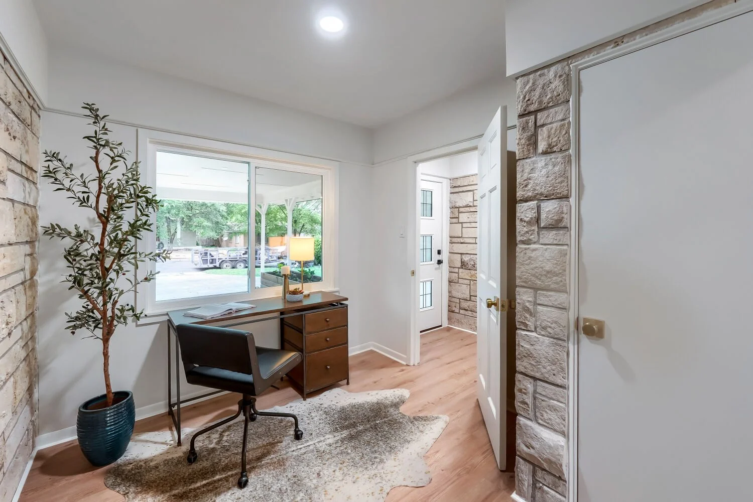 Dedicated workspace featuring stone walls and a large window in South Austin, TX.