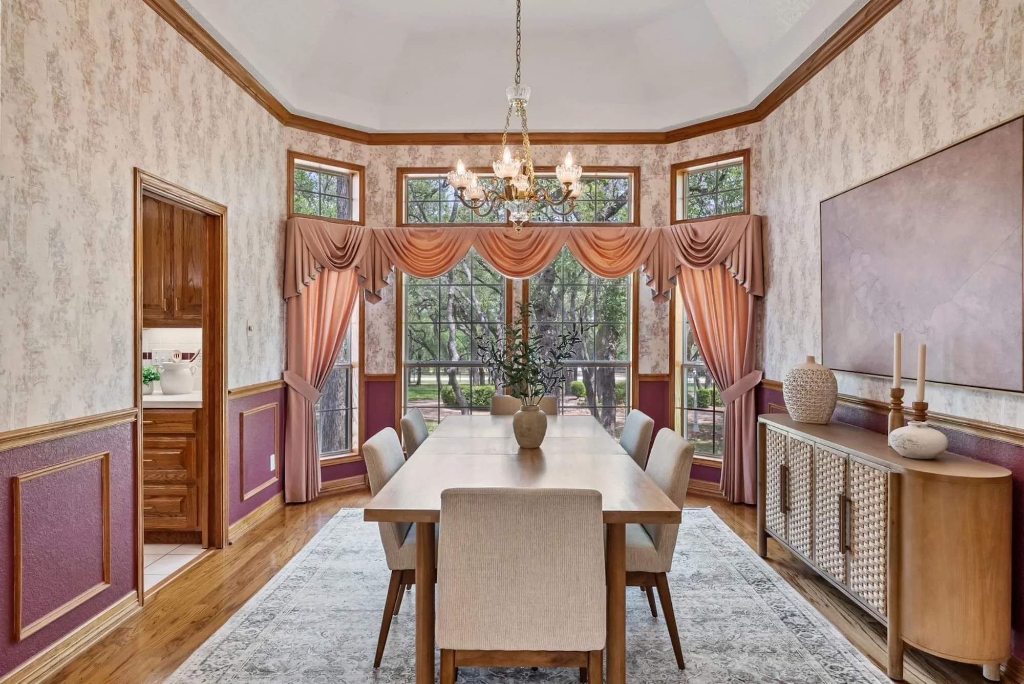 Formal dining room with a large dining table, chandelier, and tall windows overlooking the Georgetown property.