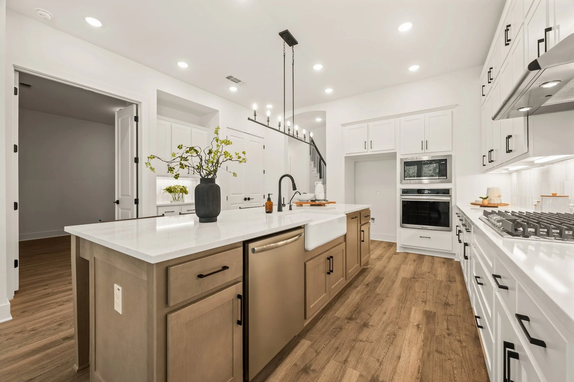 Luxury kitchen with waterfall island, farmhouse sink, and built-in appliances