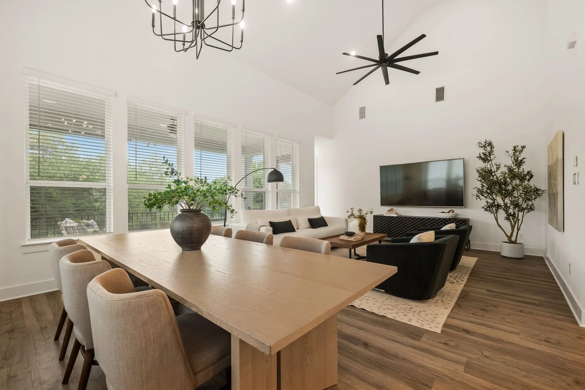 Light-filled great room with soaring ceilings, expansive windows, and luxury open-concept design