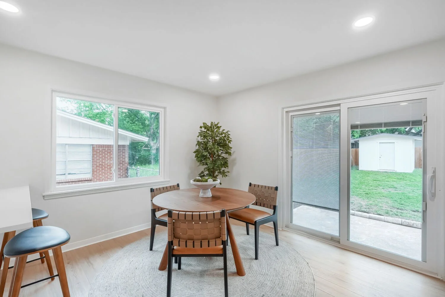 Light-filled dining area highlighted by clean lines, contemporary style, and convenient patio access.