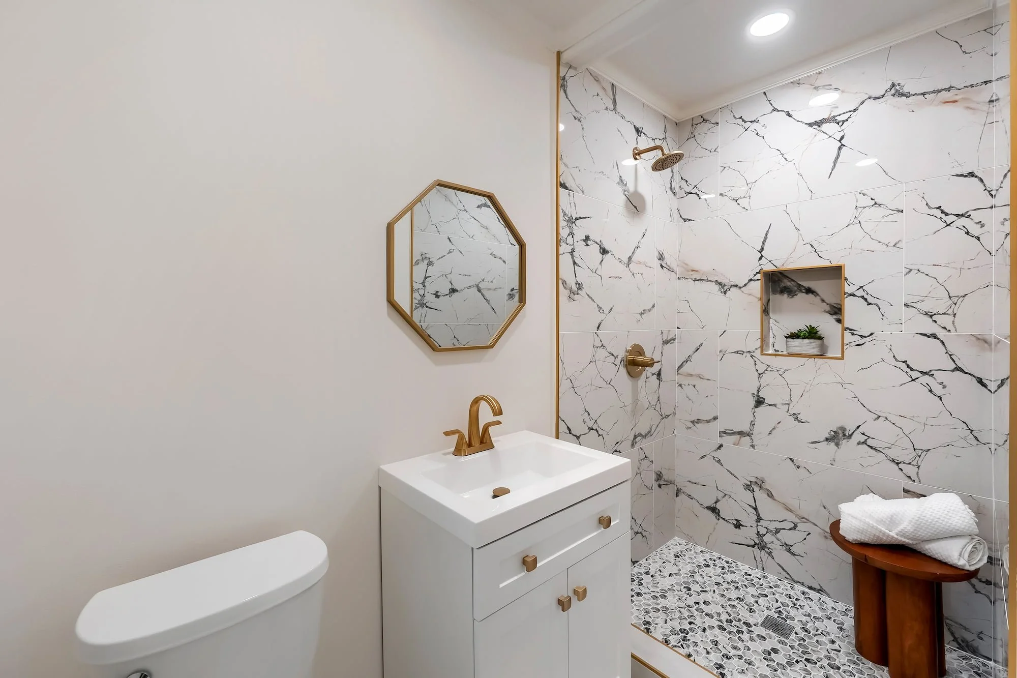 Contemporary bathroom with custom tilework and upscale fixtures.