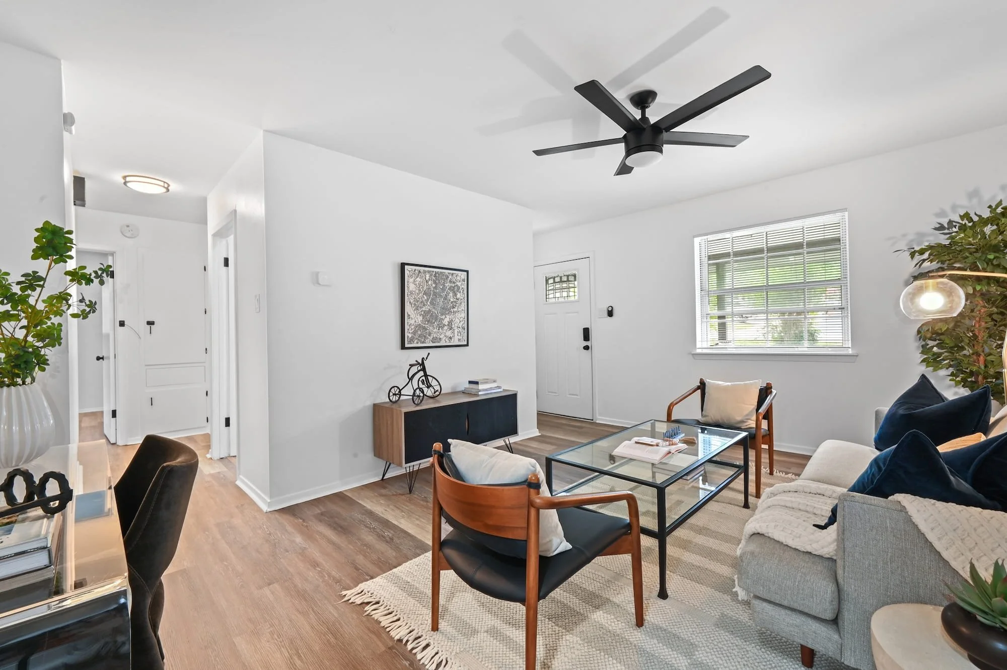 Leather accent chairs and a glass coffee table welcome guests near the front entry.