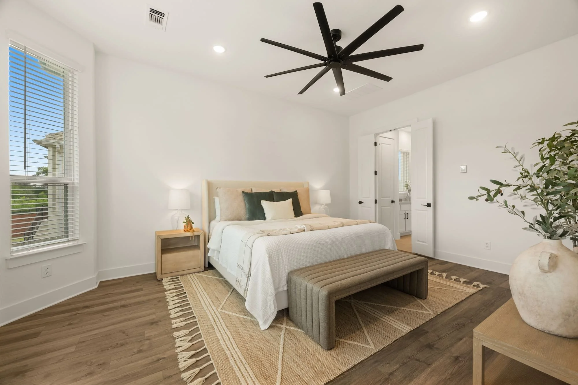 Spacious primary suite with modern finishes, designer staging, and a private ensuite bath