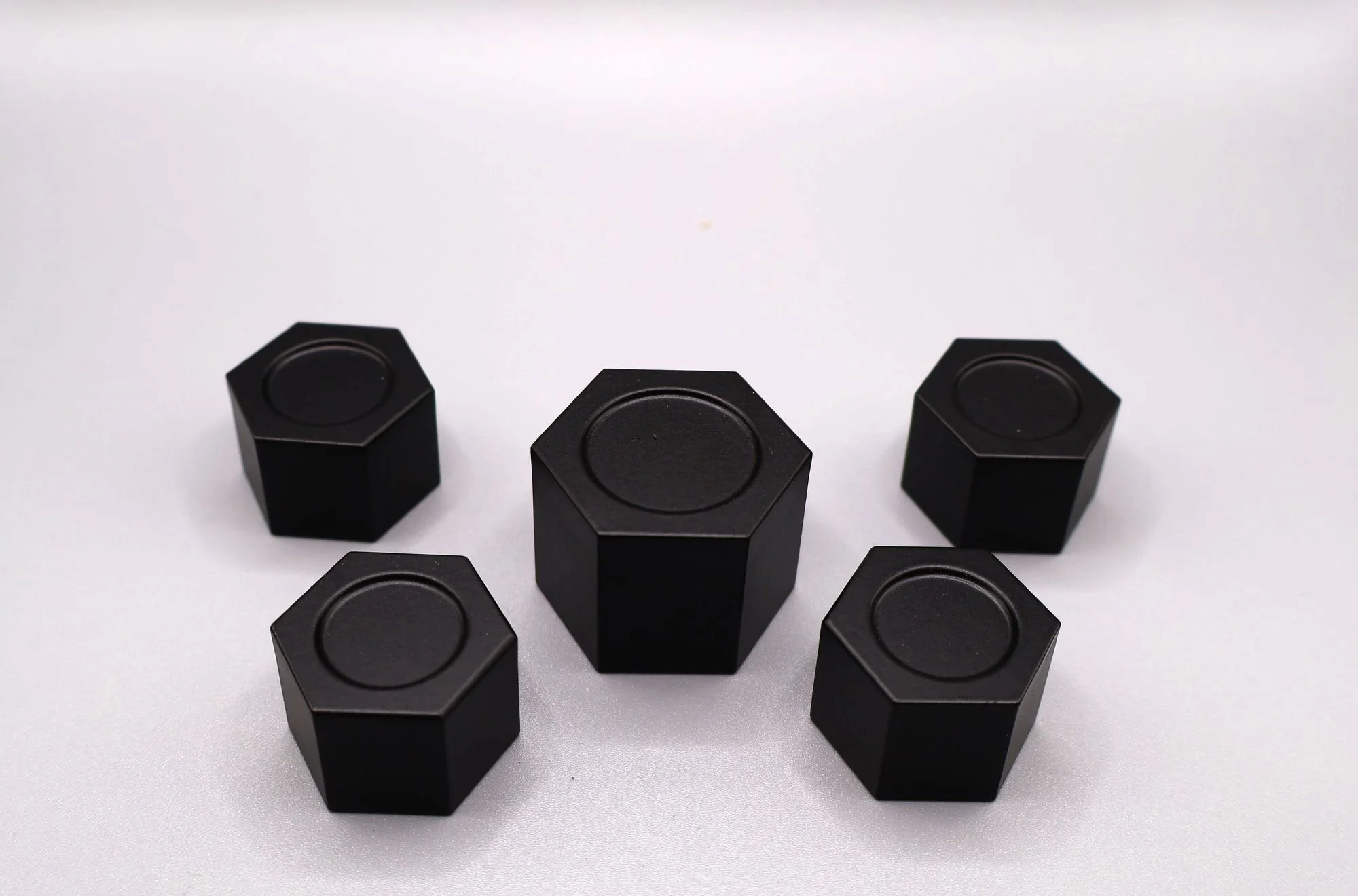 Black powder coated billet shock tower caps at a low angle showing the hex flats