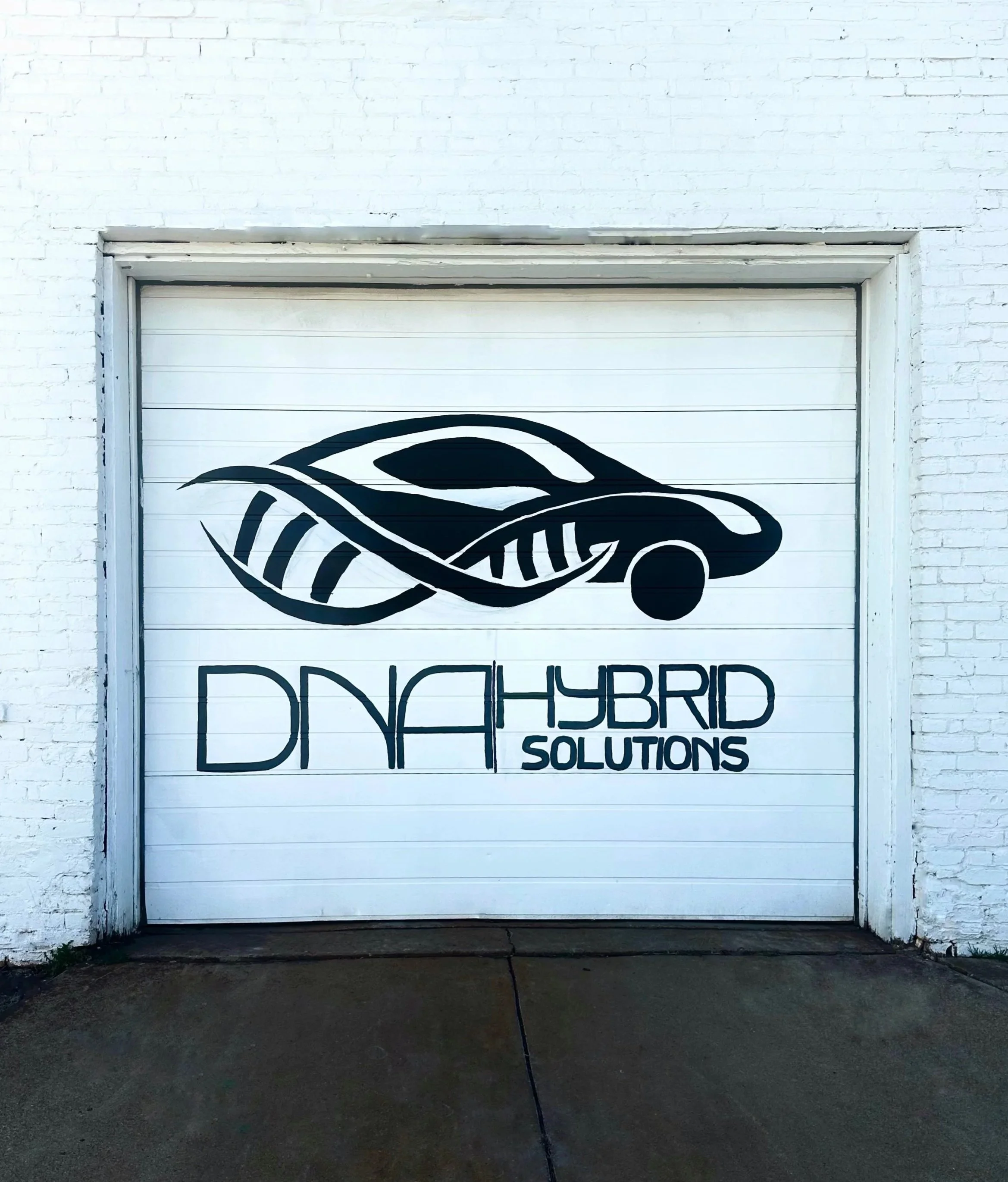 Garage door with a logo of a stylized hybrid car with dna elements and the text 'DNA Hybrid Solutions'.