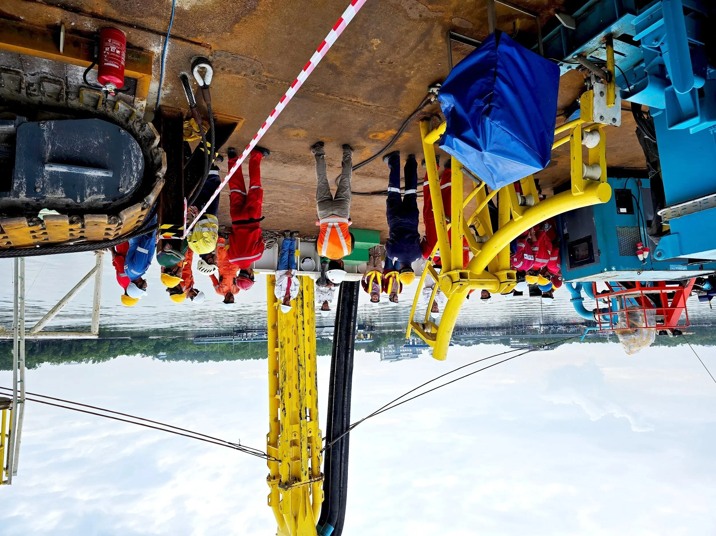 Toolbox meeting with Vertical Injector in the background.