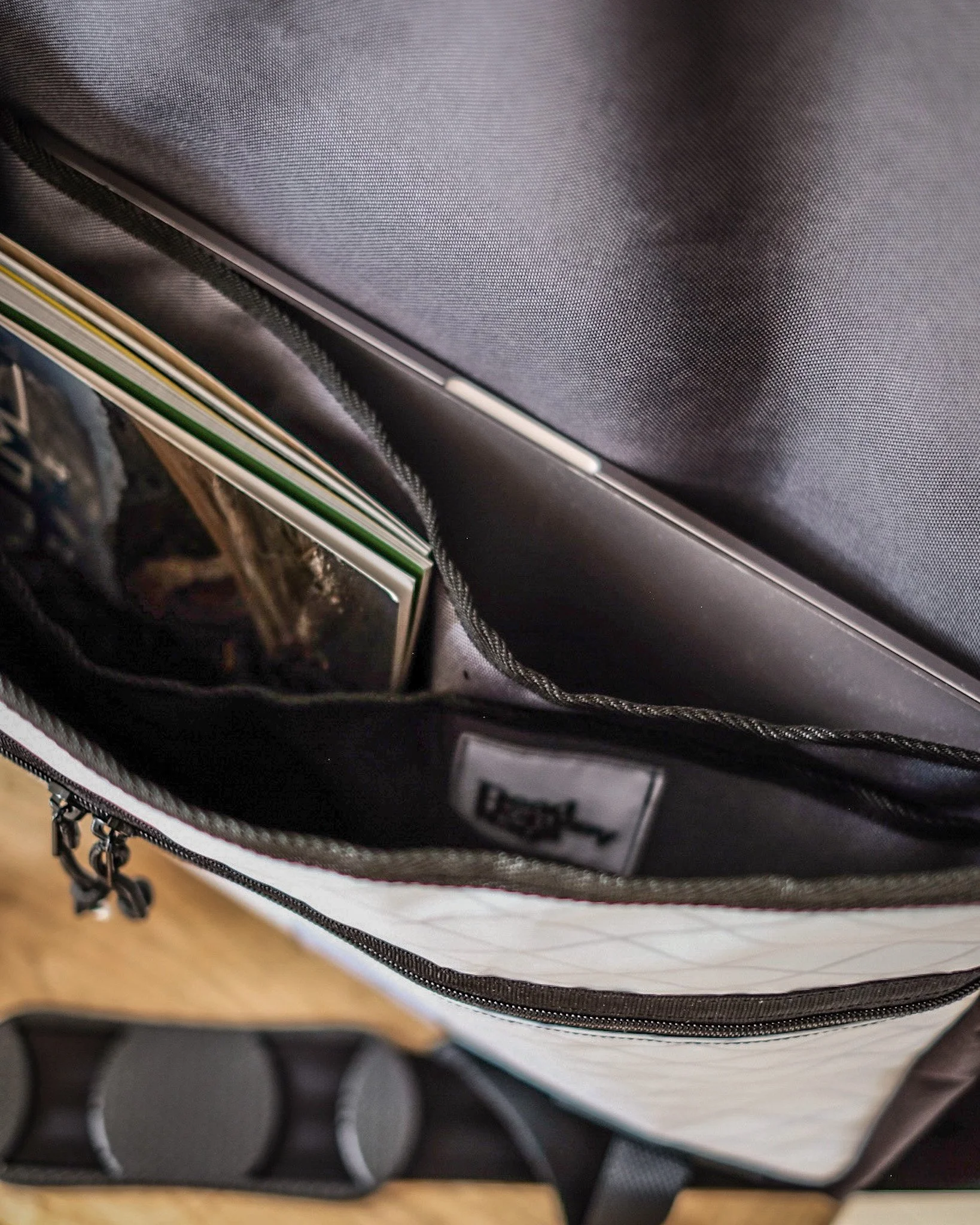 Inside of a backpack showing notebooks and a tablet.