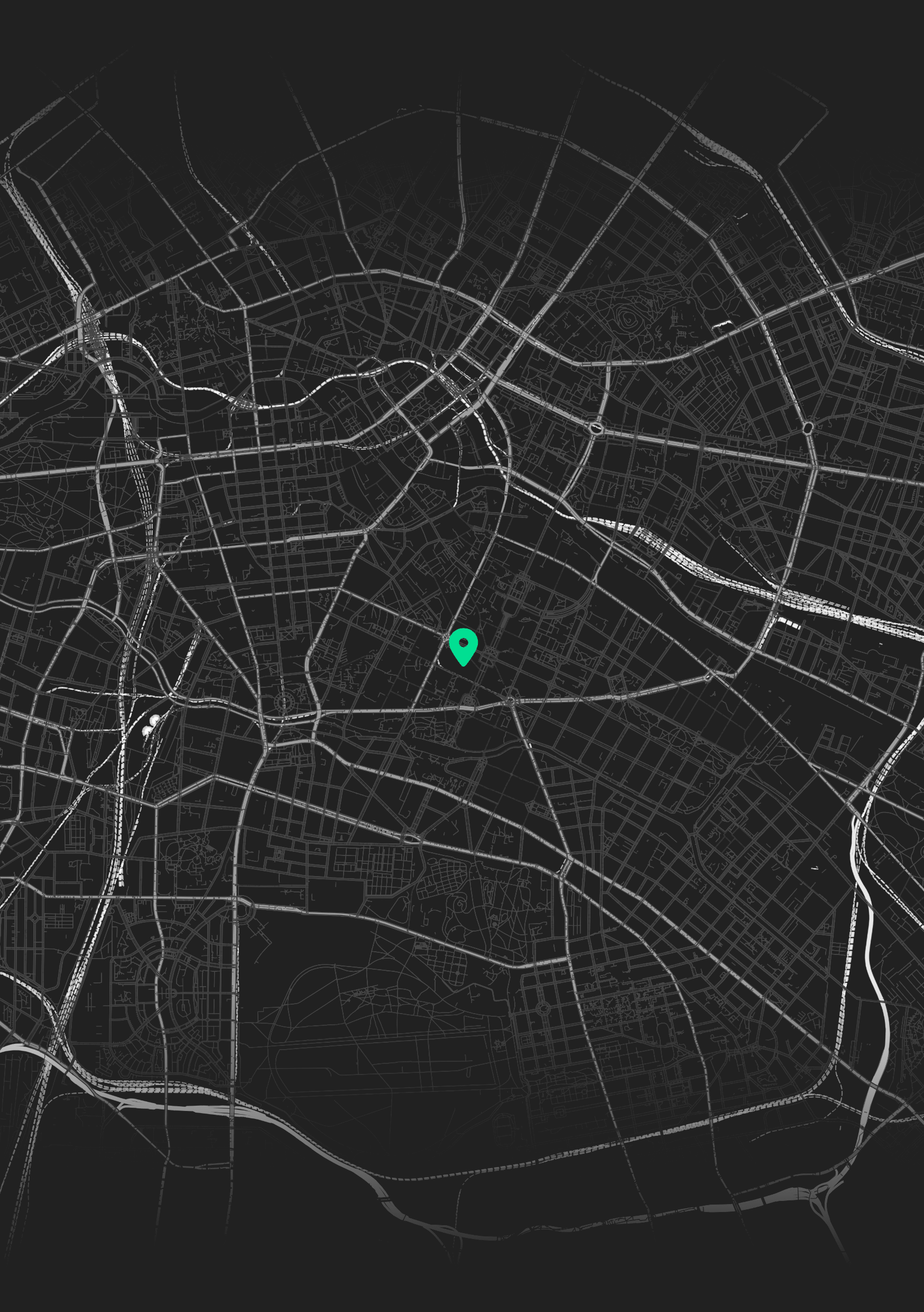 A digital map of a city at night showing streets and intersections with a green location marker in the center.