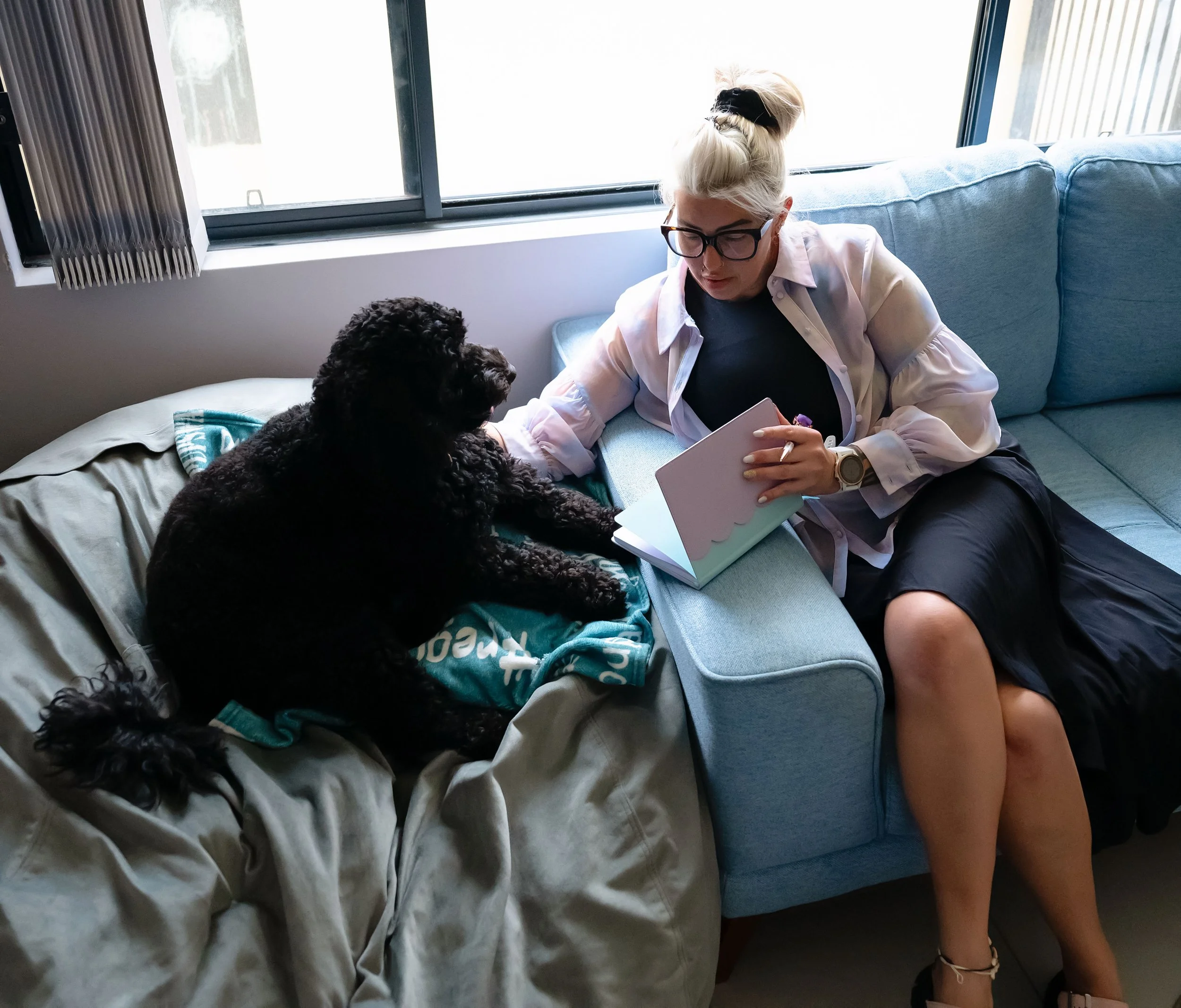 Woman on couch with dog