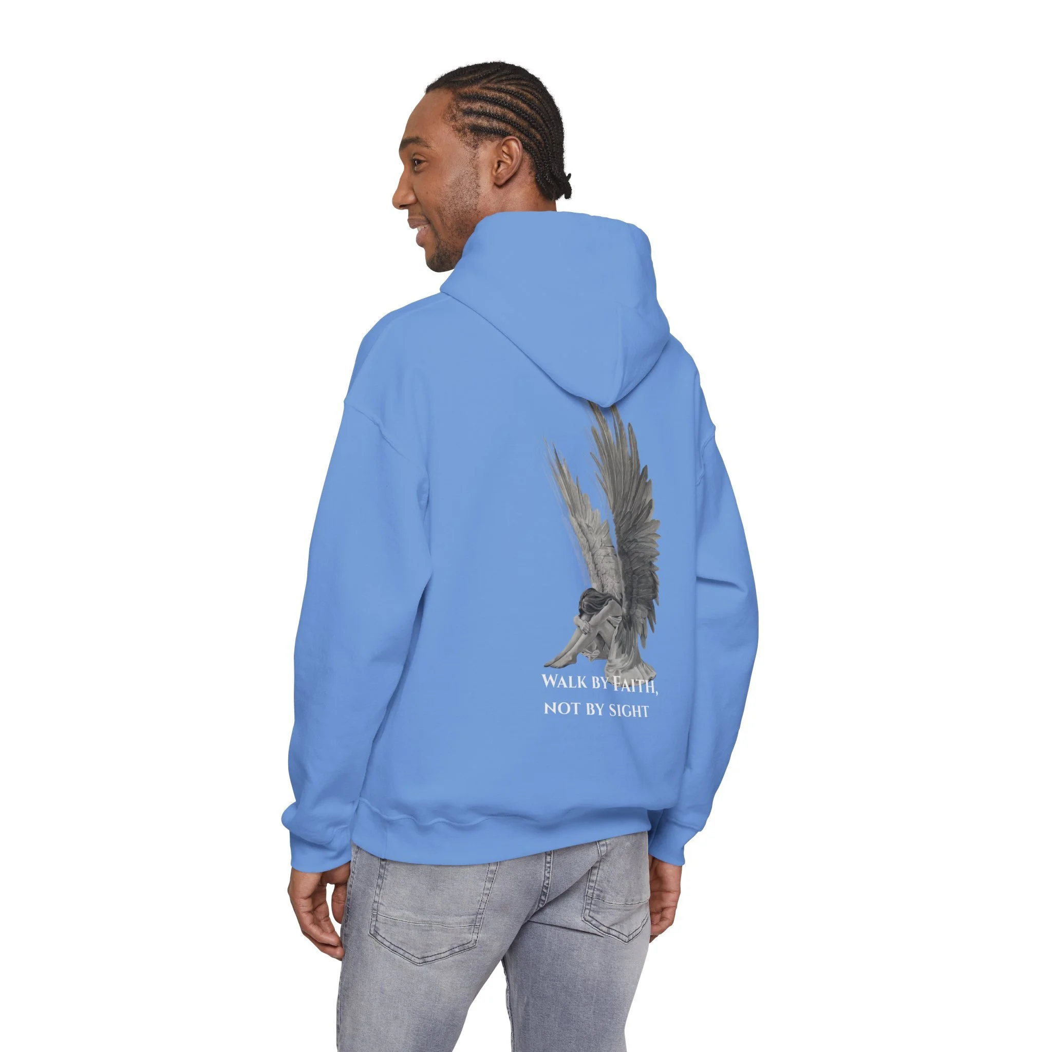 A man wearing a blue hoodie with a graphic of an angel on the back and the text 'Walk by faith, not by sight' printed underneath.