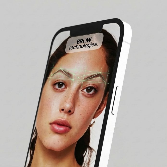 A smartphone displaying a close-up of a woman's face with augmented reality glasses and digital interface lines, with a label that says "BROW technologies."