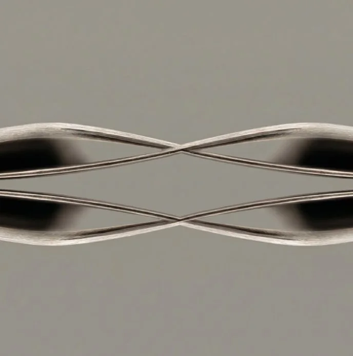 Close-up of two stainless steel medical forceps crossed and reflected on a mirror surface.