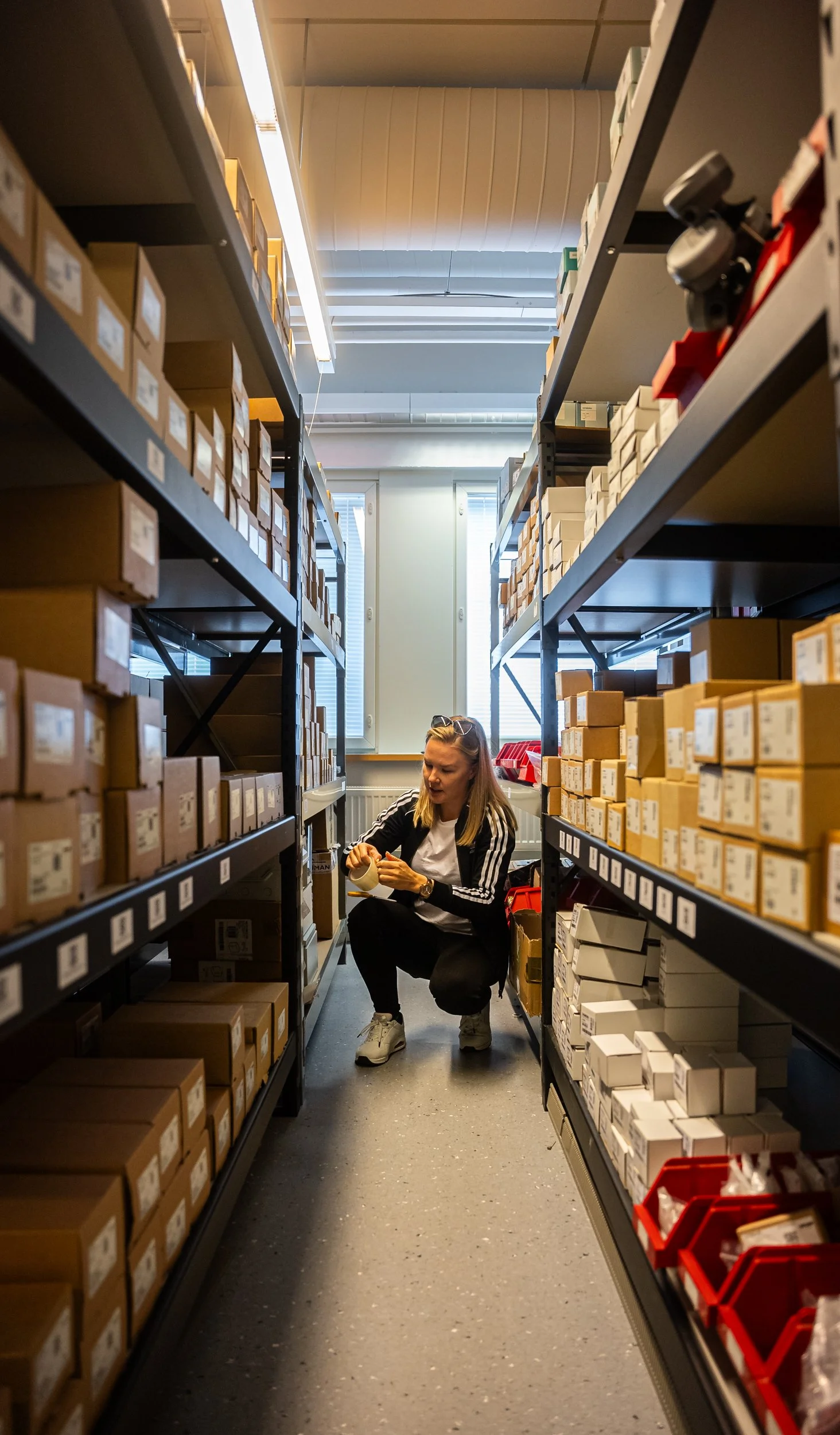 Suvi Nisula kyykyssä Helvis Expressin varastossa kuvaspäivän valmisteluissa.