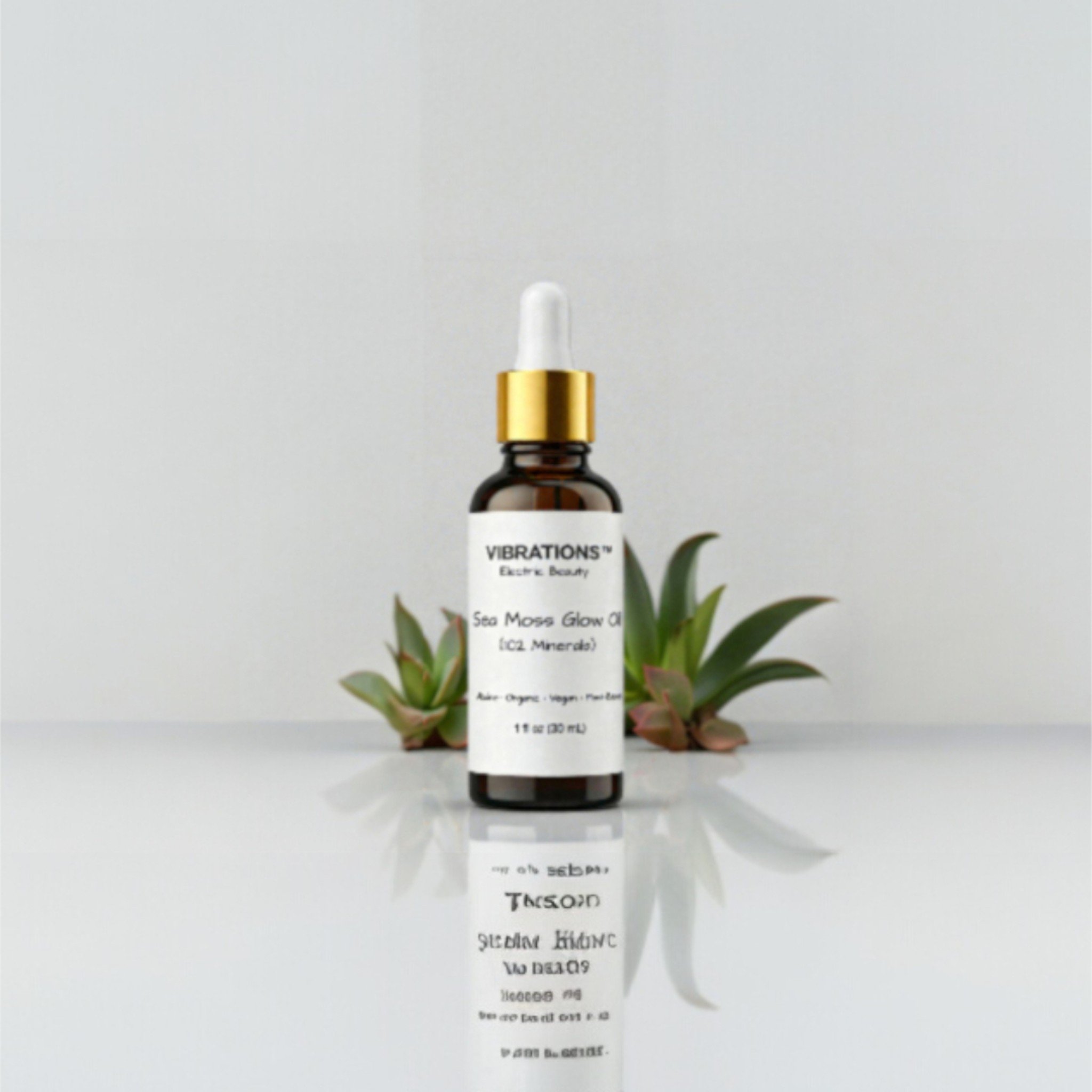 A small amber glass bottle of skincare serum with a white and gold dropper cap, labeled 'Vibrations Electric Beauty Sea Moss Glow Elixir,' positioned in front of green succulent plants on a reflective white surface against a plain light gray background.