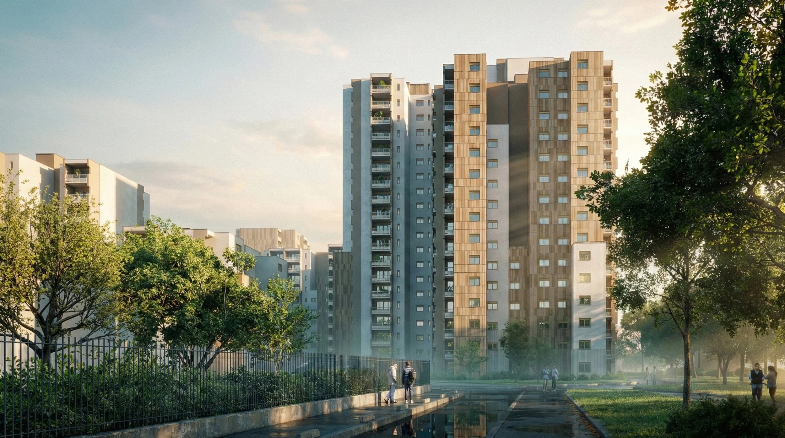 Un immeuble résidentiel moderne dans un parc avec arbres et chemins, en fin d'après-midi avec la lumière du soleil couchant.