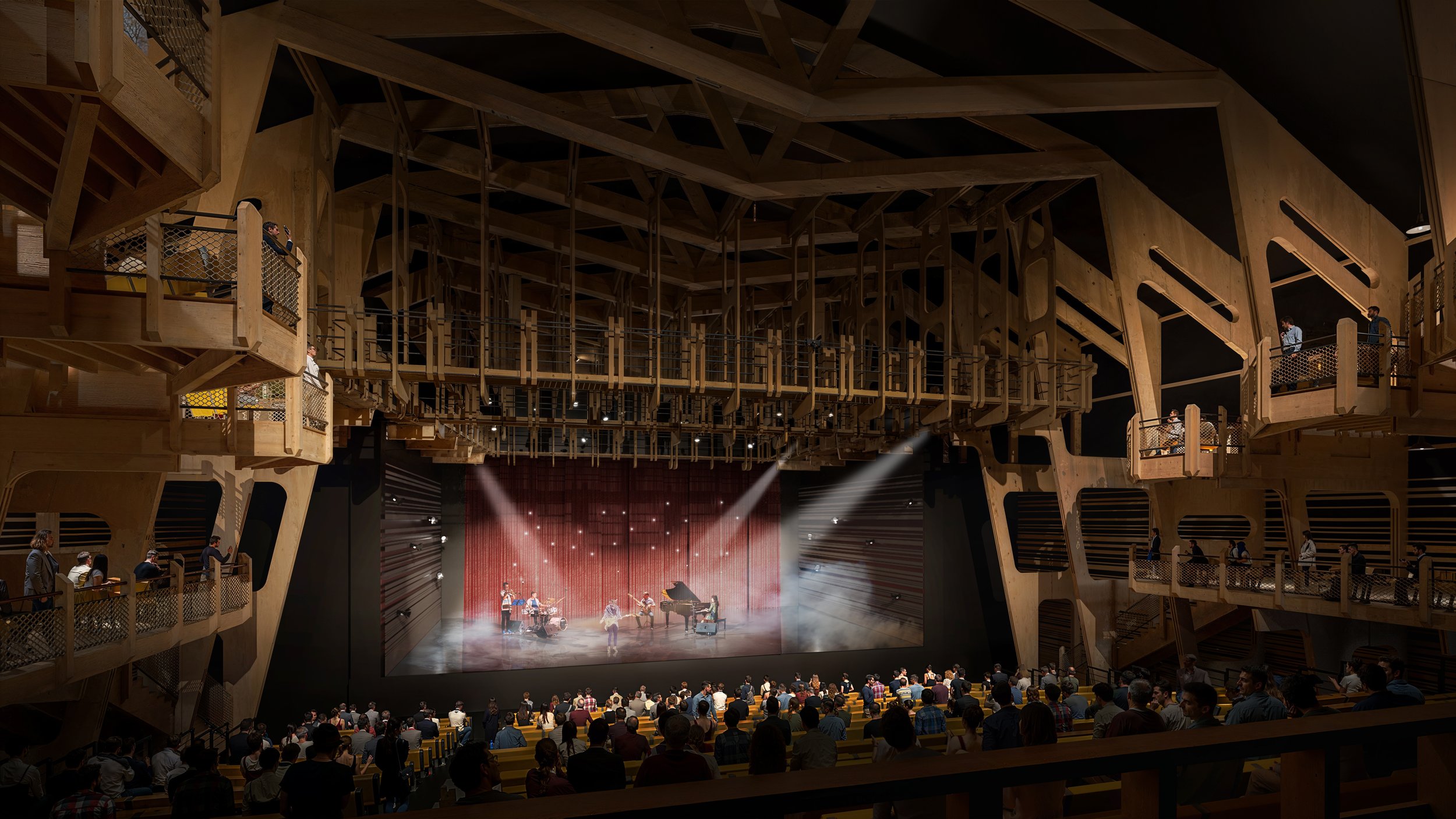 Salle de spectacle avec un public regardant une performance musicale sur scène, éclairée par des projecteurs, avec des murs en bois et plusieurs niveaux de balcons.