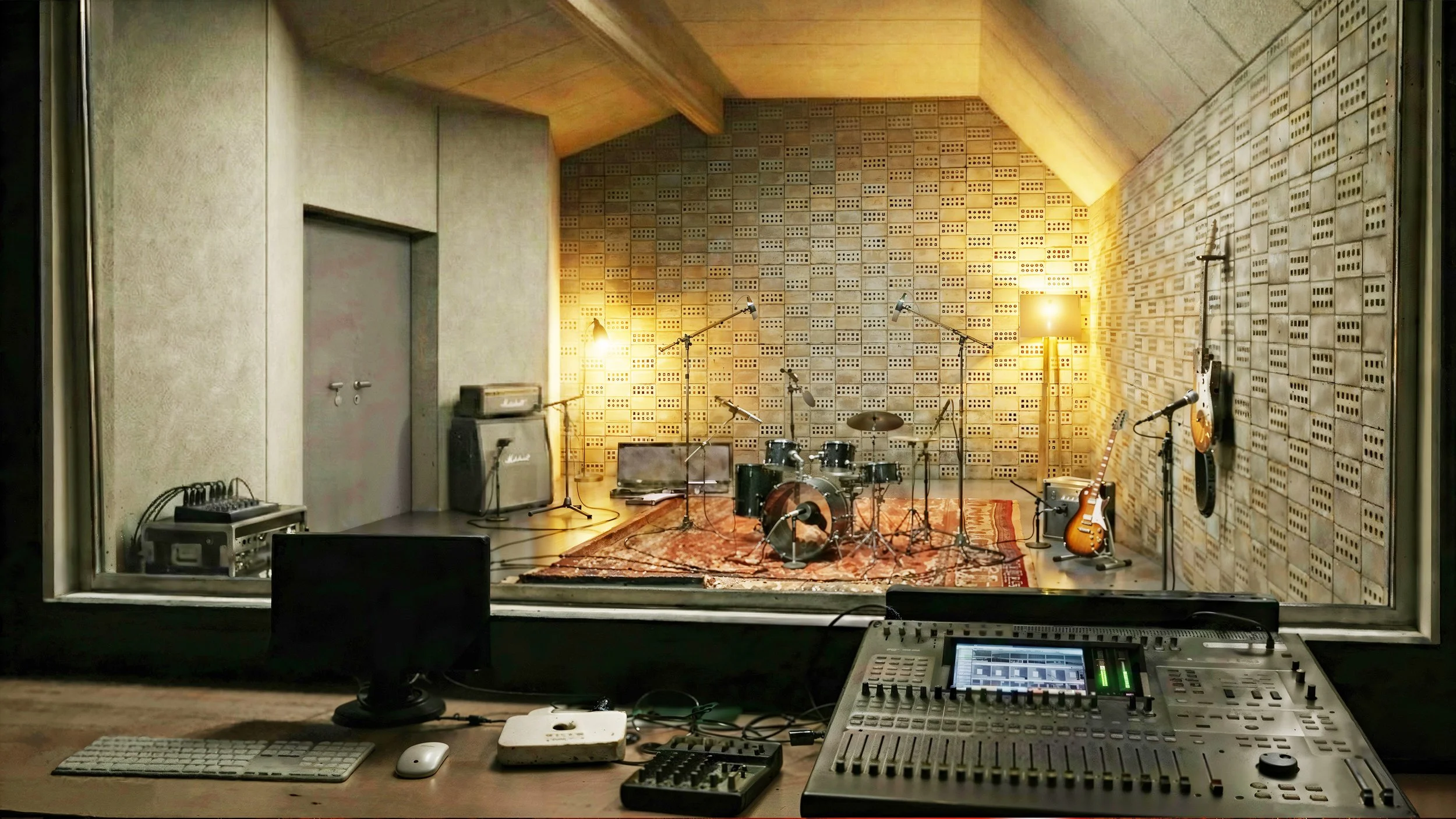 Salle de répétition de musique avec instruments comme batterie et guitares, vue depuis la cabine d'enregistrement.