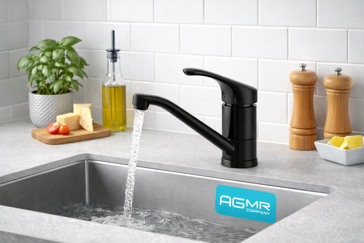 A modern kitchen sink with a black faucet, water running, a plant in a white pot, a bottle of olive oil with a black pump, a cutting board with cheese and cherry tomatoes, wooden salt and pepper shakers, and a dish with lemon wedges on a gray countertop with a white tiled backsplash.