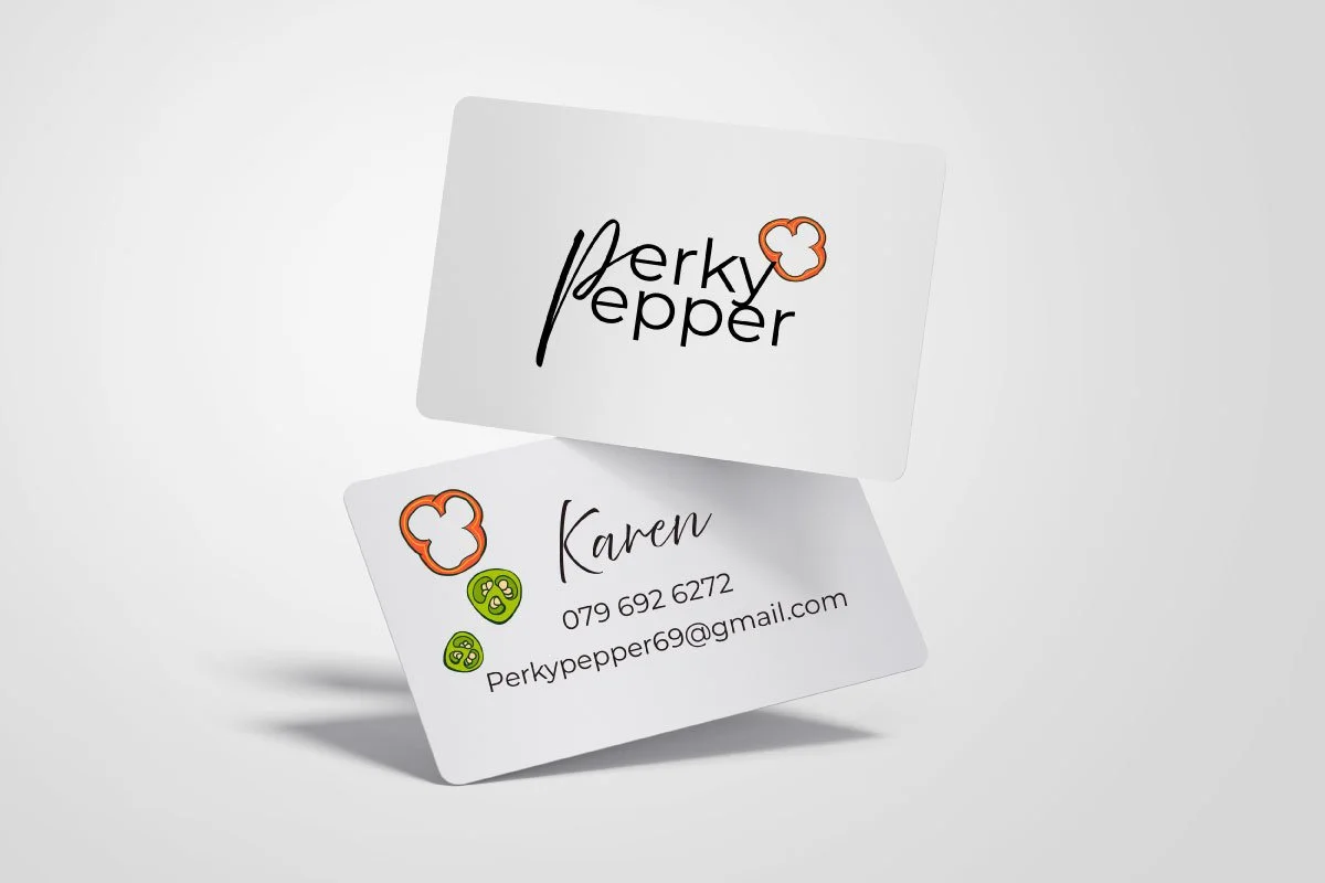 Two white business cards, one displaying a logo with the text "Perky Pepper" and a pepper outline, the other with the contact information for Karen, including a phone number and email, with colorful pepper and face icons.