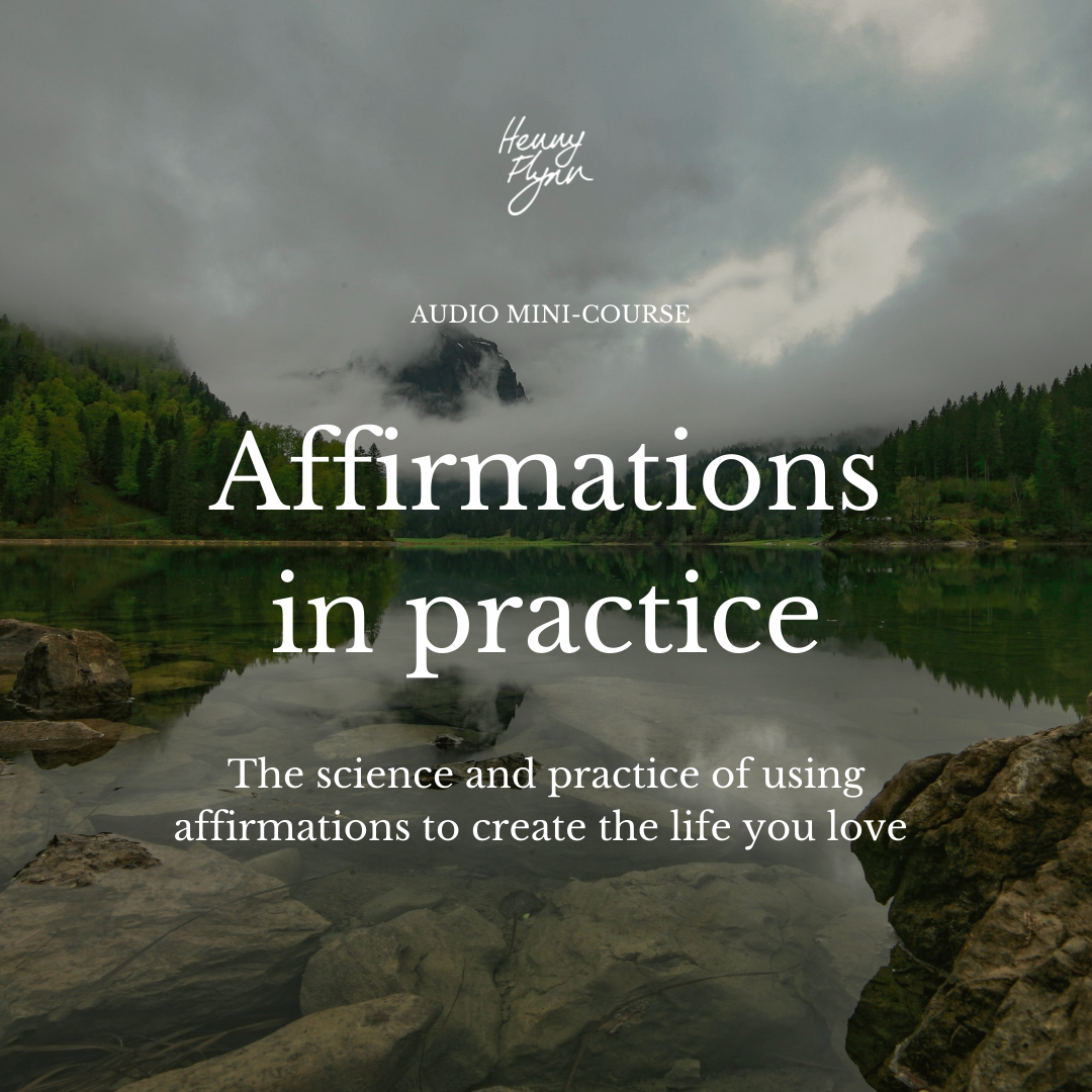 A scenic view of a lake with rocks and trees, mountains and cloudy sky in the background, and overlaid text about affirmations in practice.