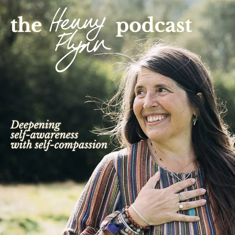 A woman with long dark hair smiling outdoors, wearing a colourful striped top and layered bracelets. Text on the image includes 'the Henny Flynn podcast' and 'Deepening self-awareness with self-compassion.'