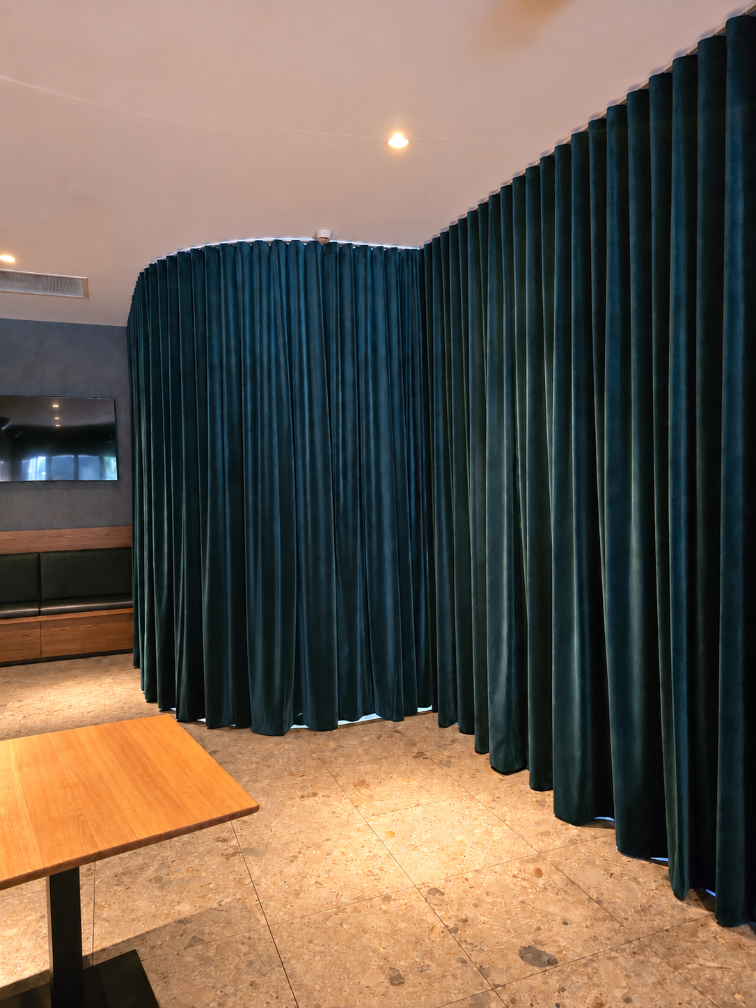 Curved track teal velvet S-Wave curtains in a Perth restaurant fit-out by Glorious Home Decor
