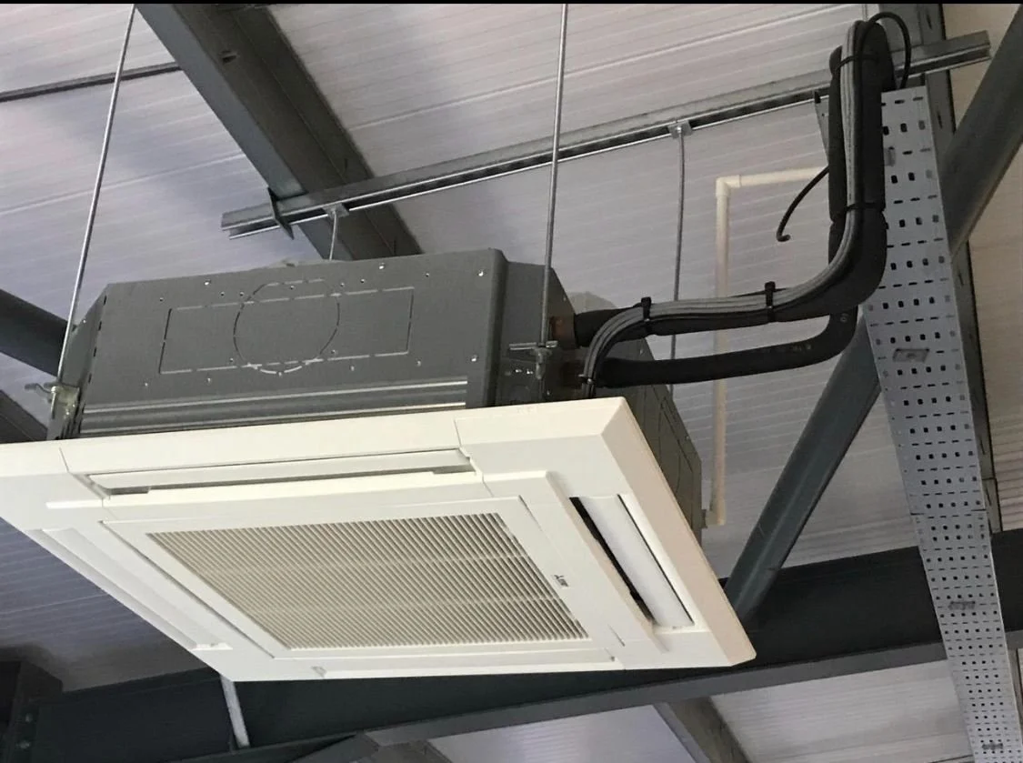 Ceiling-mounted air conditioning unit in an industrial or commercial building.