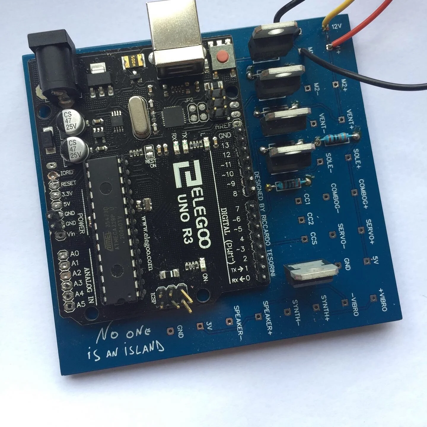 A blue Arduino Uno R3 microcontroller board with various electronic components and connectors installed.
