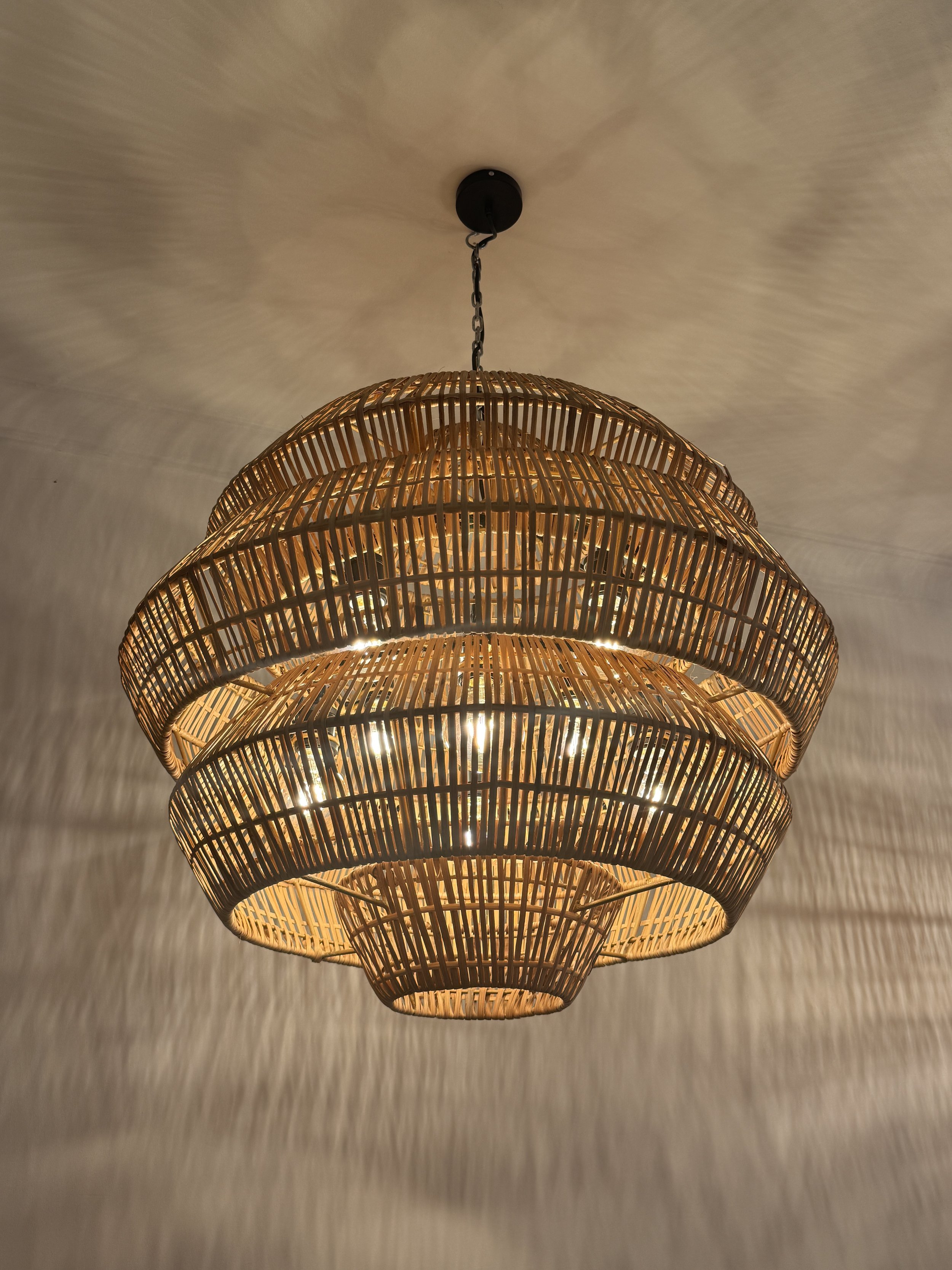 A bold spherical form crafted with intricate weaving, casting beautiful shadow patterns while adding a sculptural statement to any room.