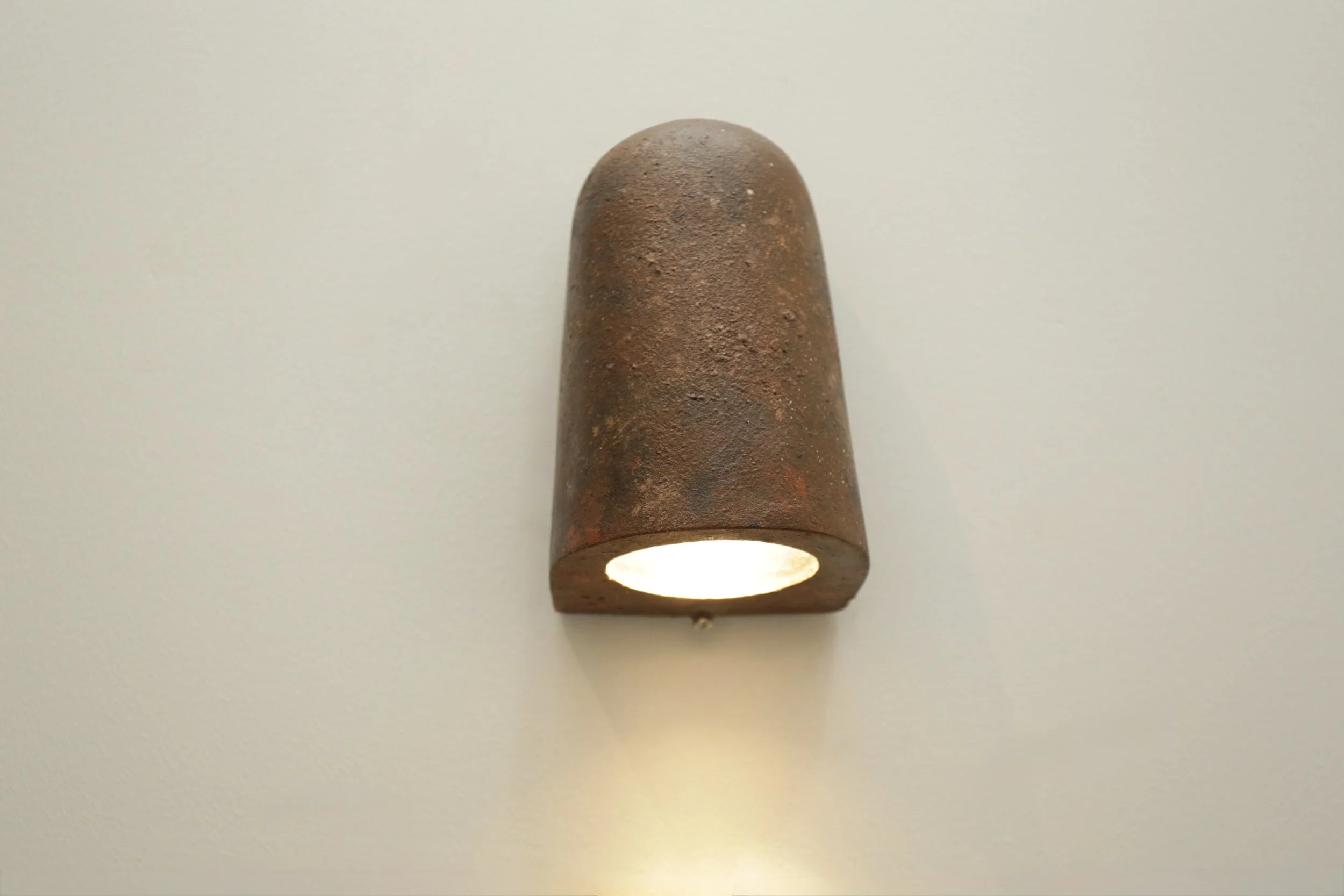 The rust wall light . this is textured wall light that adds depth and warmth, casting a soft upward and downward glow ideal for accent lighting.