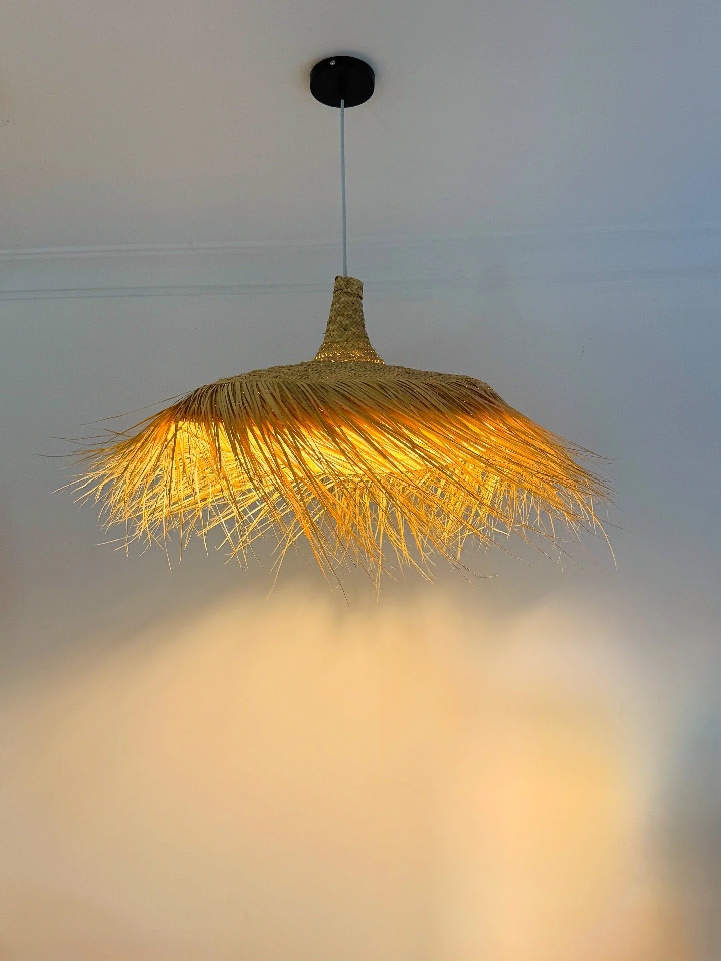 A delicate cascade of hand-woven fibers creates a warm, golden glow that feels light, organic, and elegant. Perfect for adding softness to modern interiors.