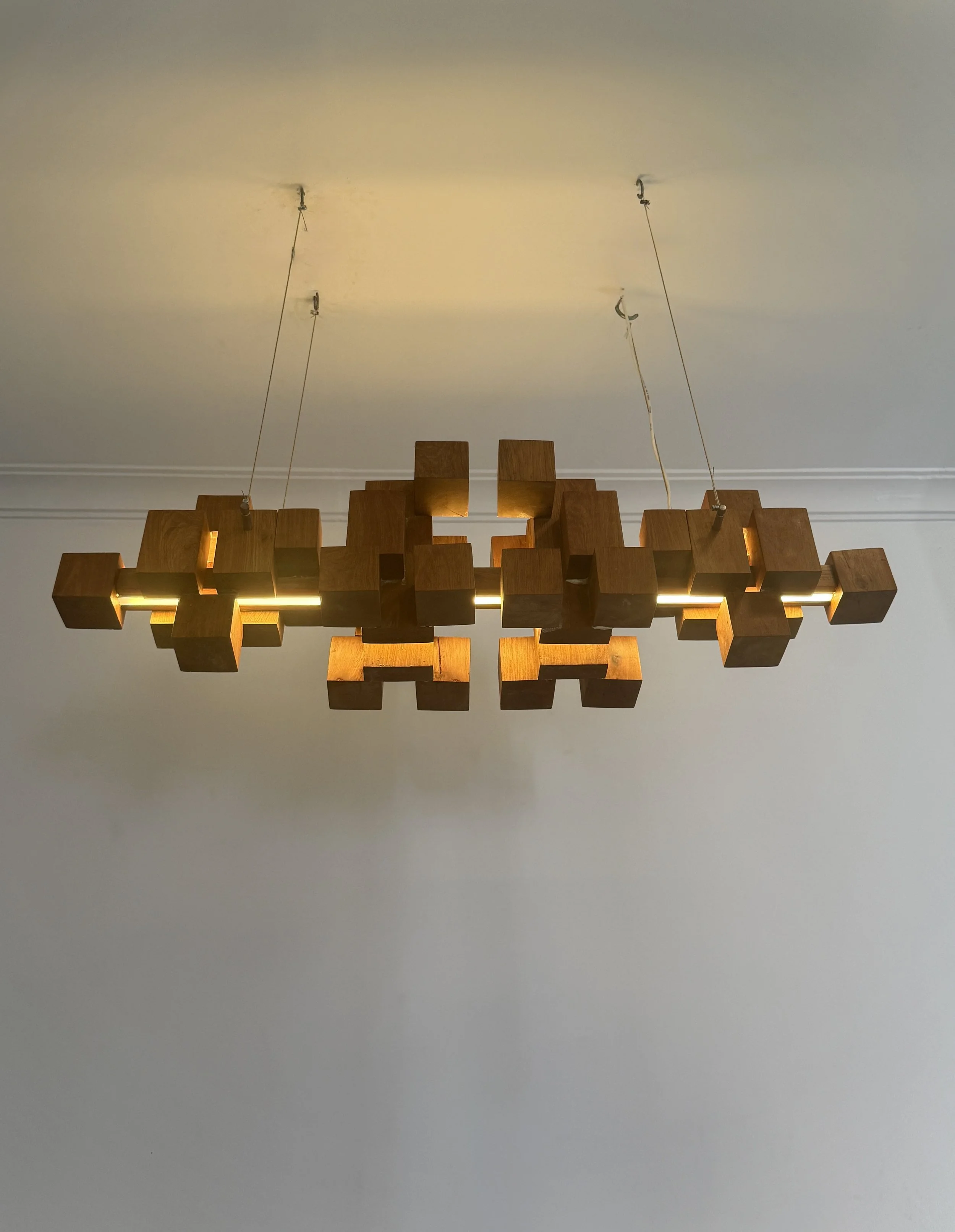 A bold, architectural lighting piece composed of geometric elements, offering both artistic presence and functional illumination.