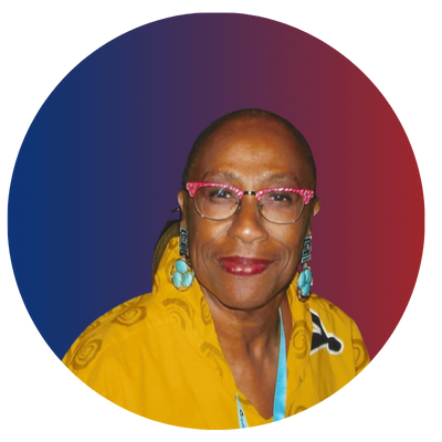 Portrait of an older woman with short hair, wearing glasses, turquoise earrings, and a yellow patterned blouse, smiling against a multicolored background.