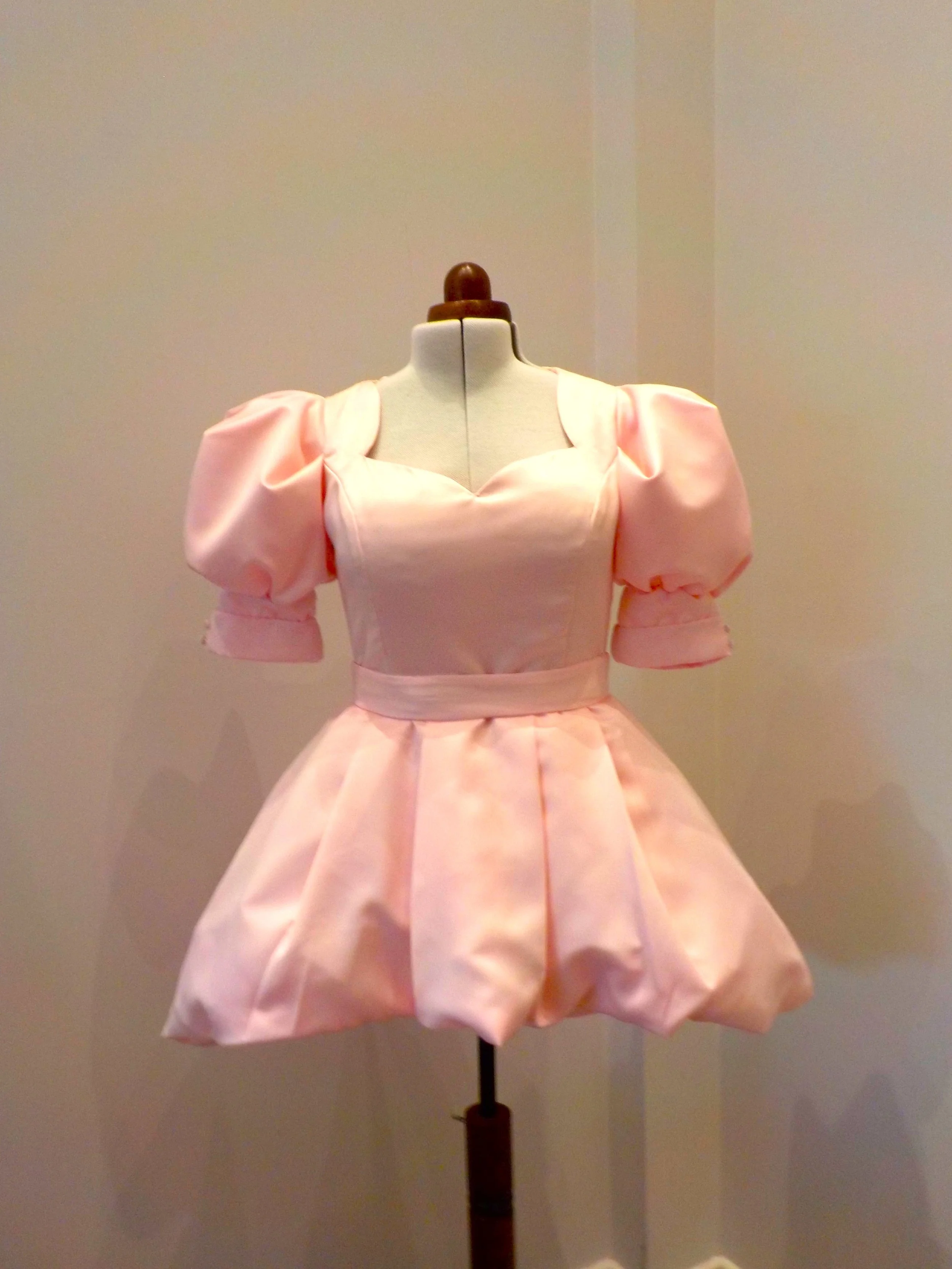 Bespoke powder pink puffball hem mini wedding guest dress by Beatrice Espinosa