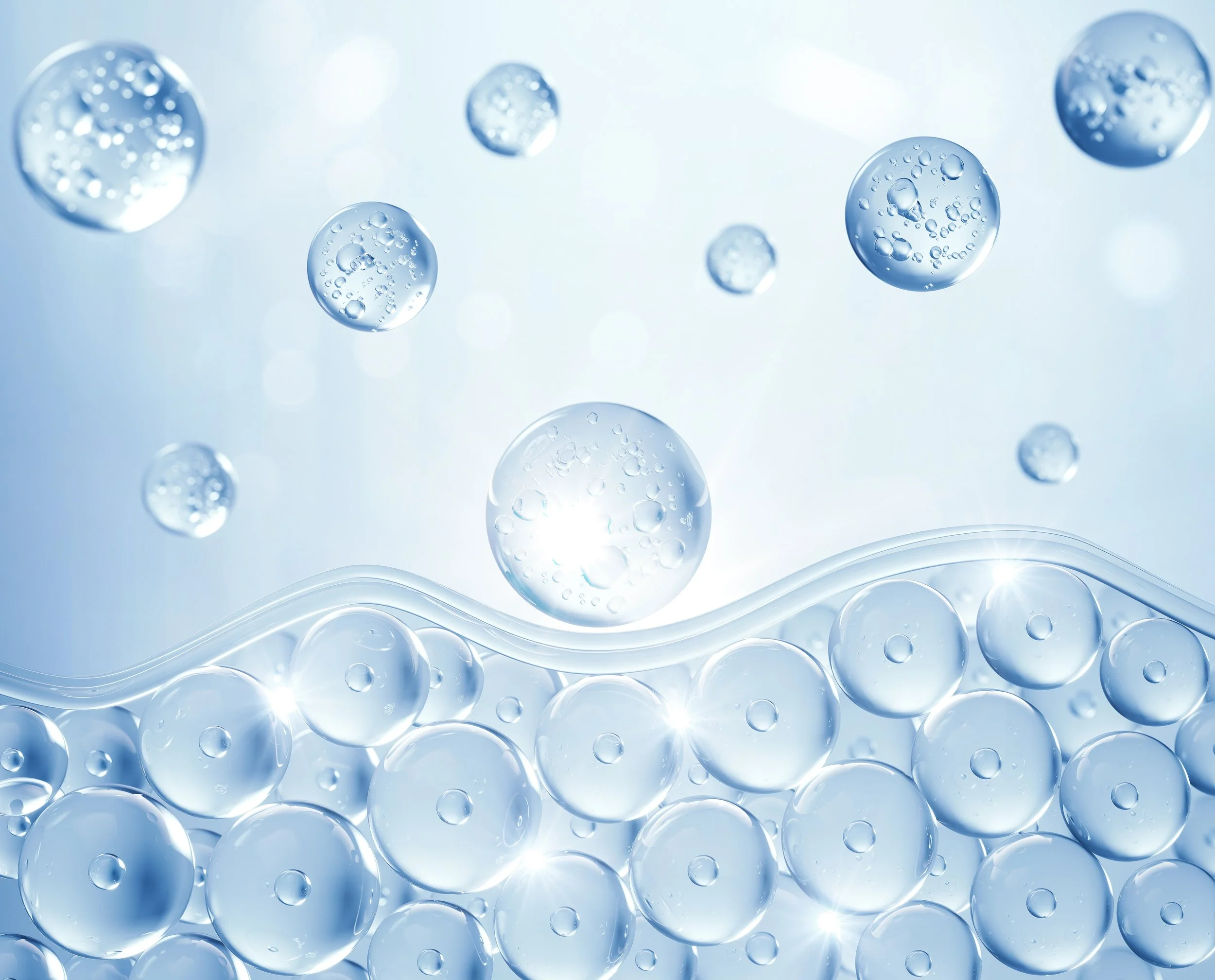 Numerous translucent bubbles floating in a light blue background, with some bubbles clustered near the bottom and a few scattered in the middle and upper part of the image.