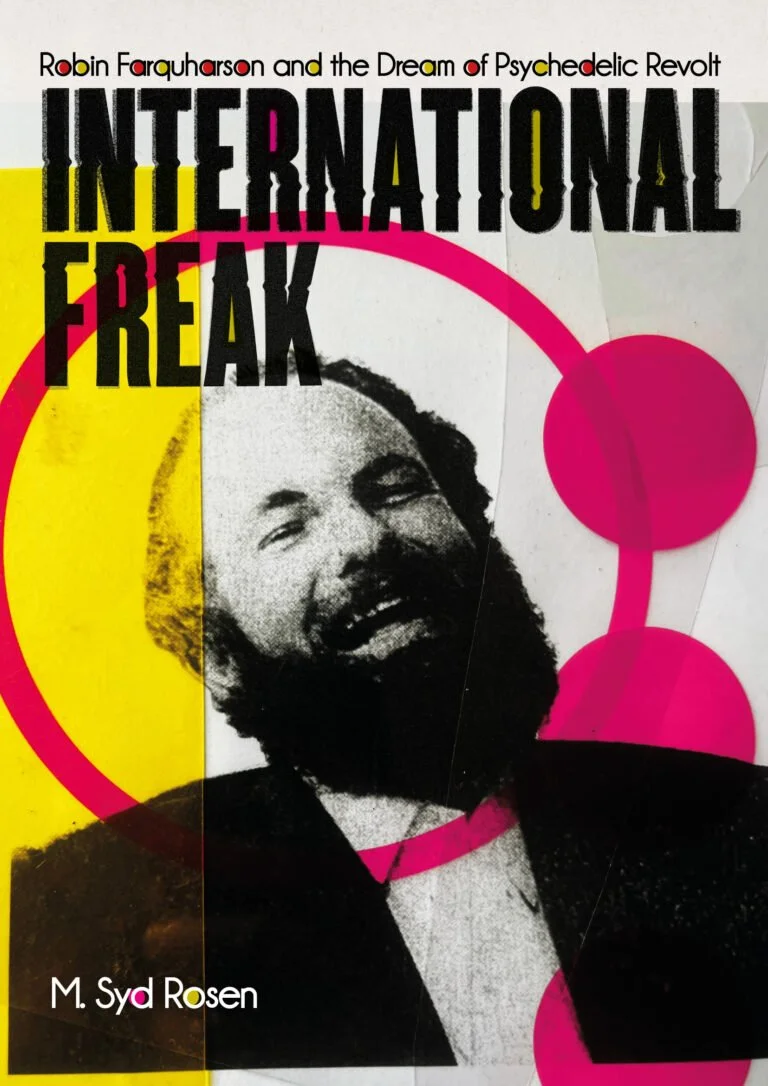 Book cover titled 'International Freak' by Robin Farquharson, featuring a black and white photo of a laughing man with a beard, surrounded by pink and yellow abstract circles and lines, with additional title information and author's name.