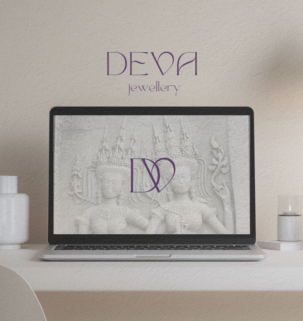 Laptop displaying a black and white carved stone relief of two figures, with the text 'DEVA jewellery' in purple above and above the figures.