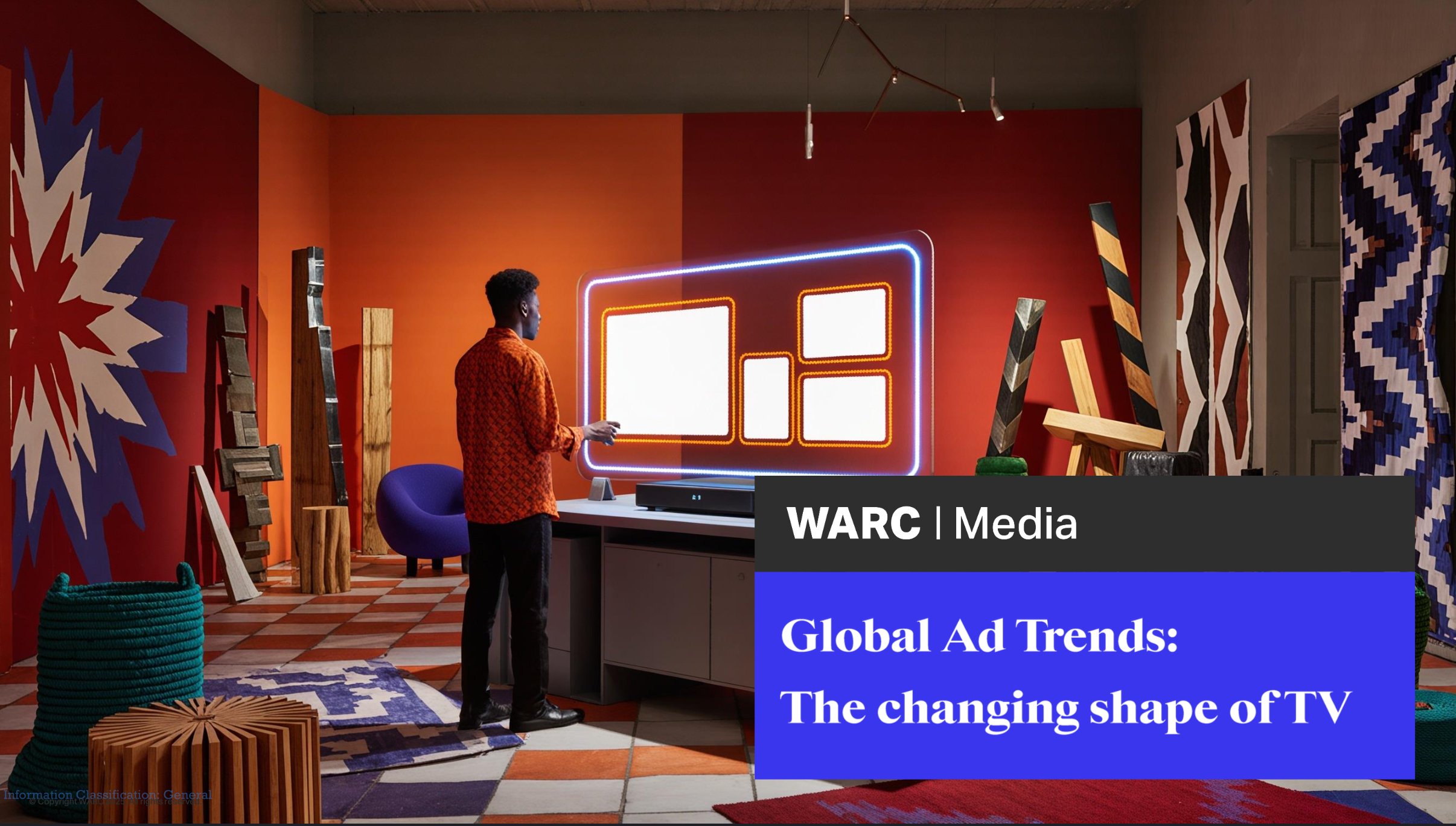 A person standing in a modern, colorful room with abstract wall art, patterned textiles, and a large, illuminated television display on a table.