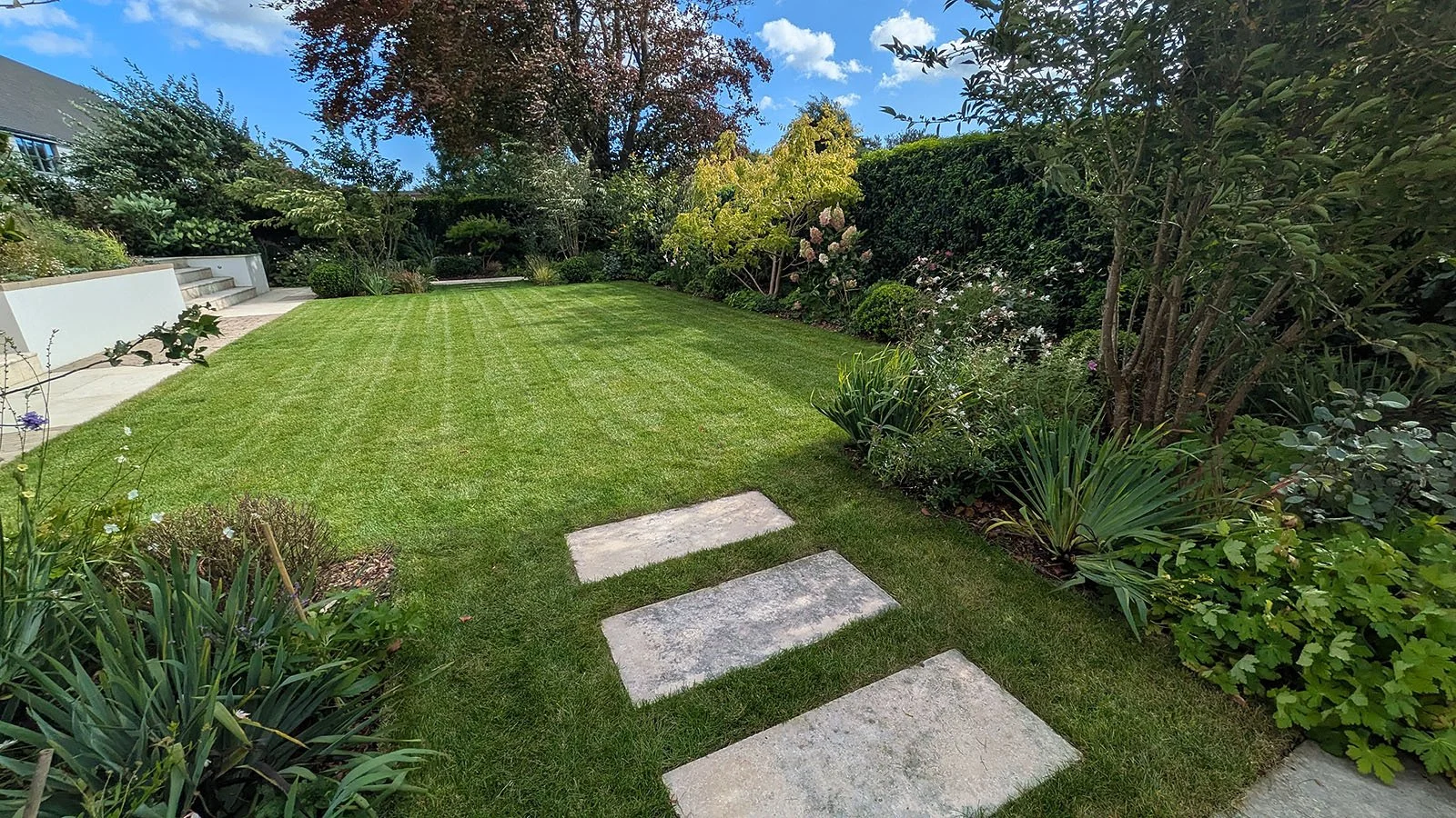Perfect striped lawn and neat herbaceous borders