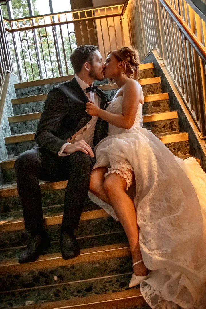 Niamh pulling Peter in for a passionate kiss by his lapel at a Nottingham wedding editorial, with her garter visible