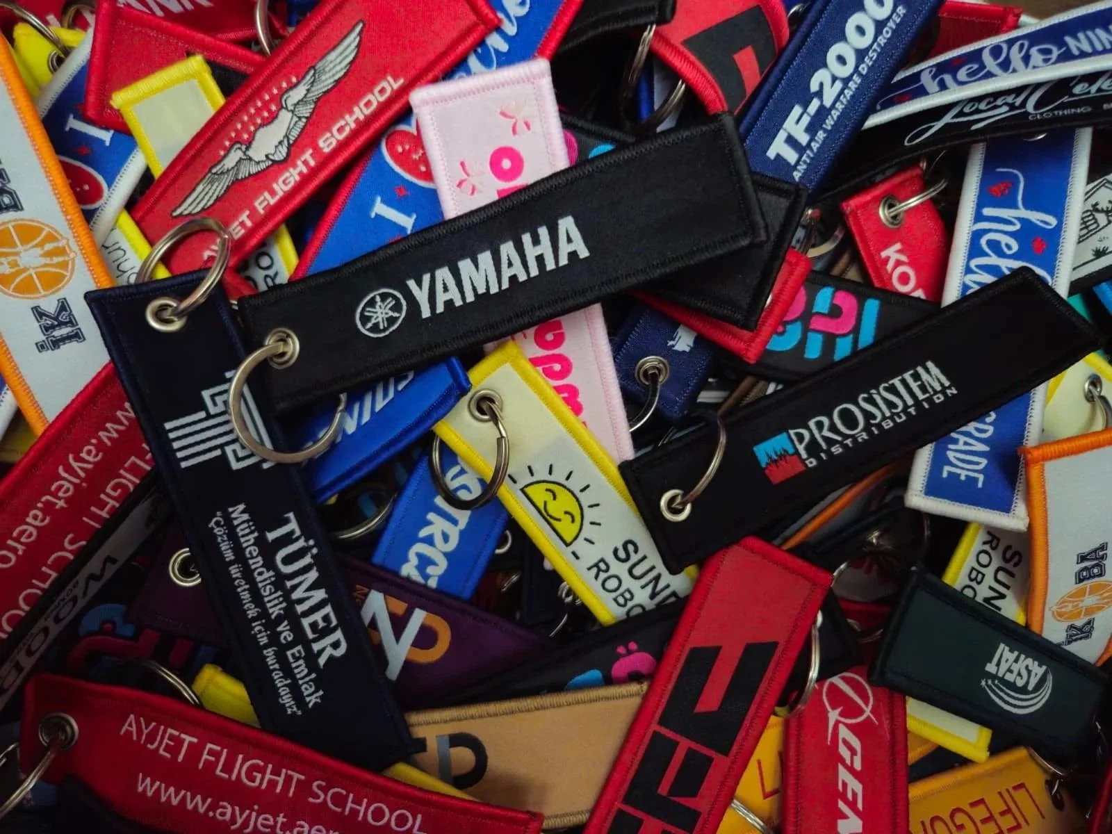 Collection of colorful luggage tags featuring various logos and text.