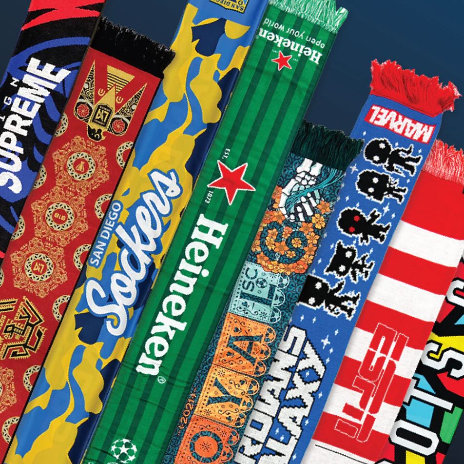 A collection of colorful sports scarves featuring various team logos and designs, laying side by side on a dark surface.